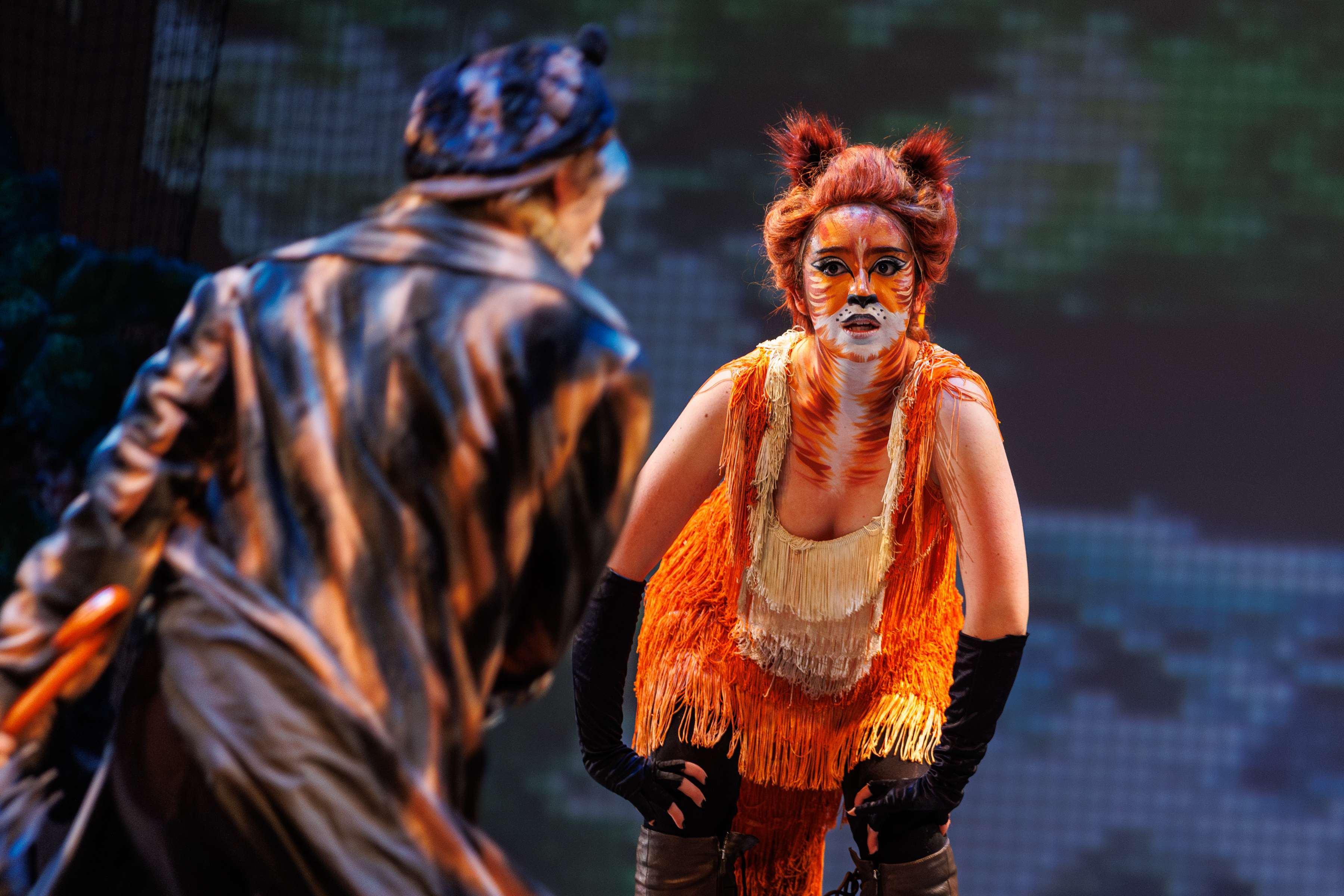 a woman dressed as a fox and a man dressed as a cat