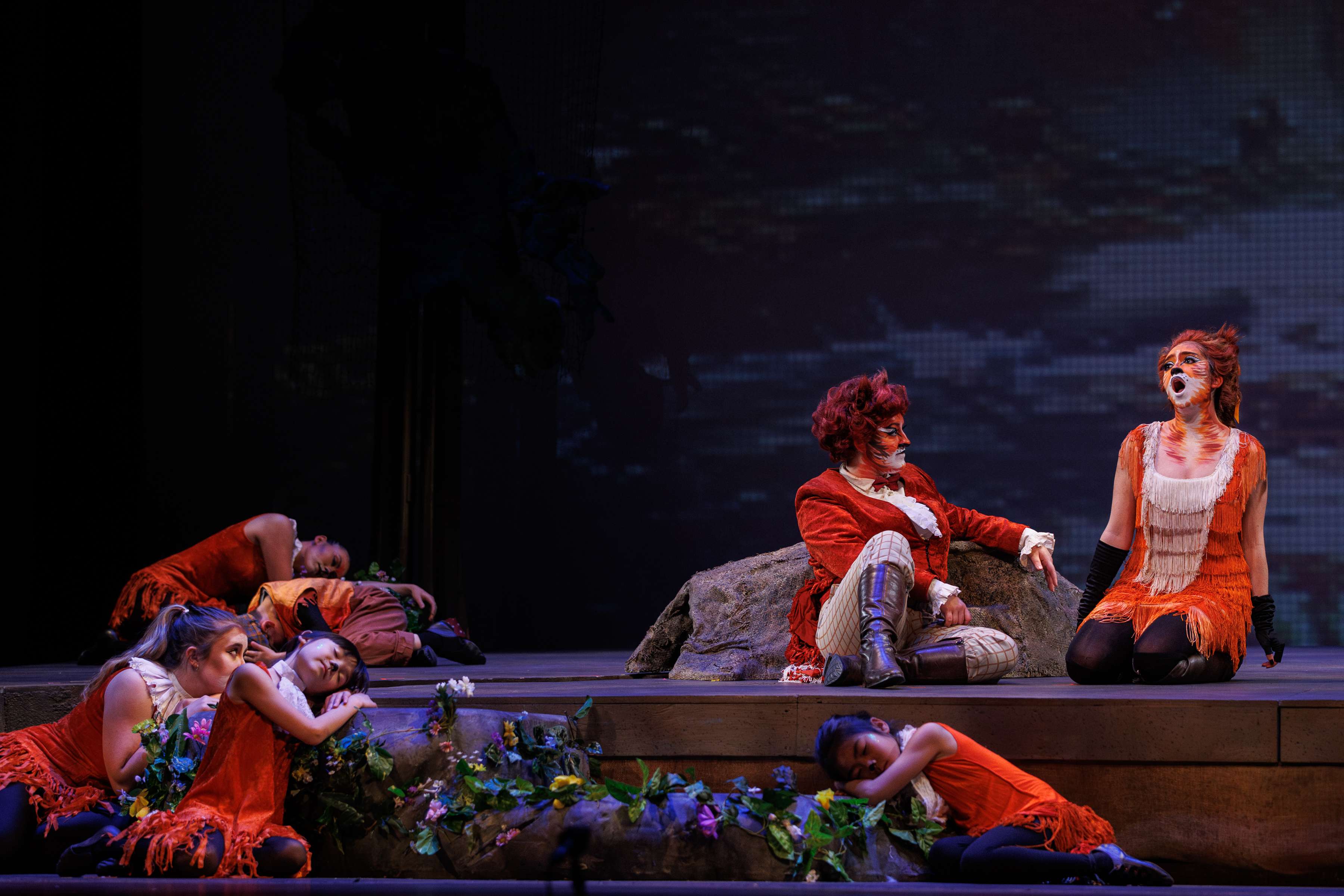 a group of people sitting on a stage
