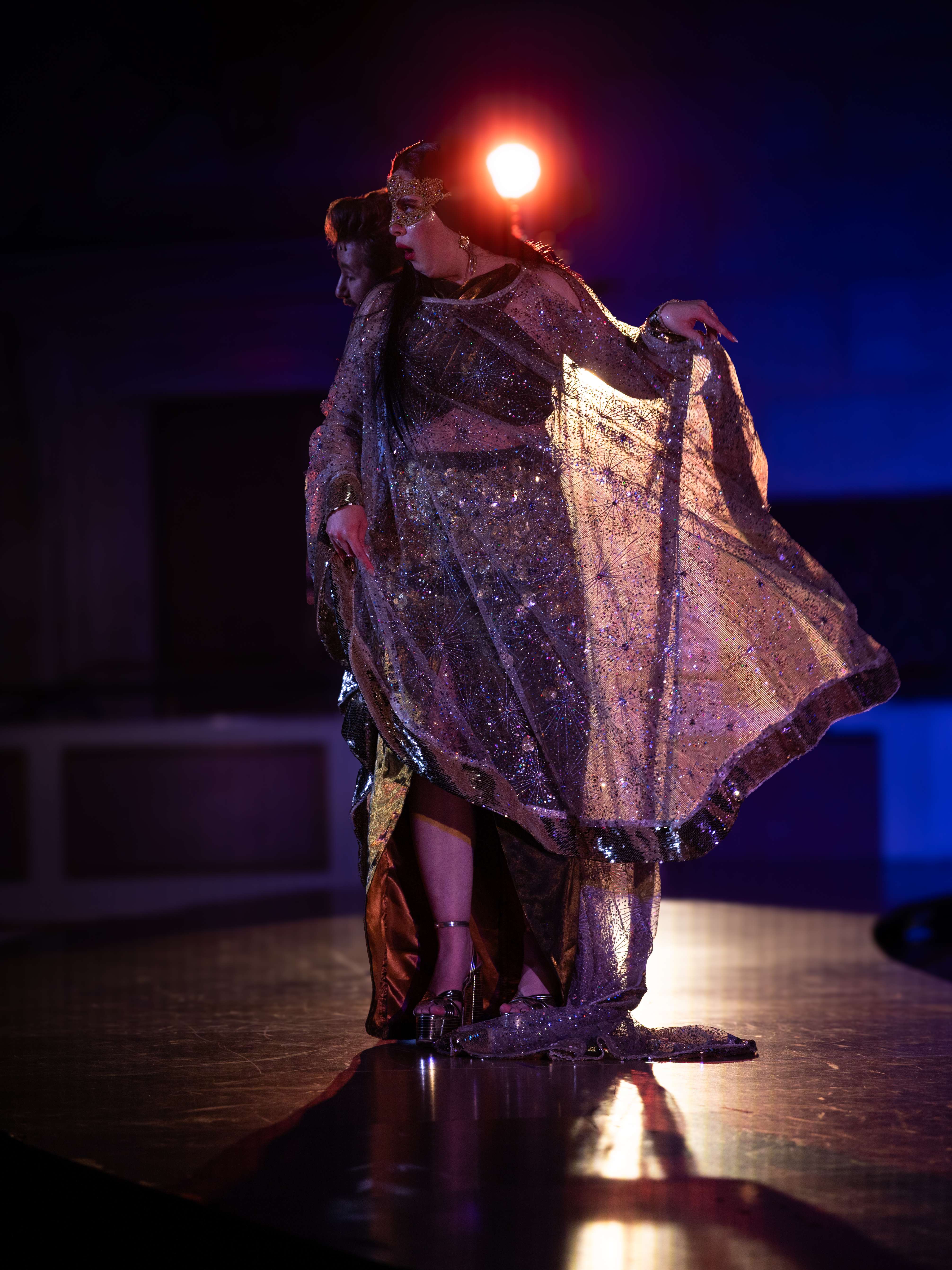 a woman in a costume on a stage