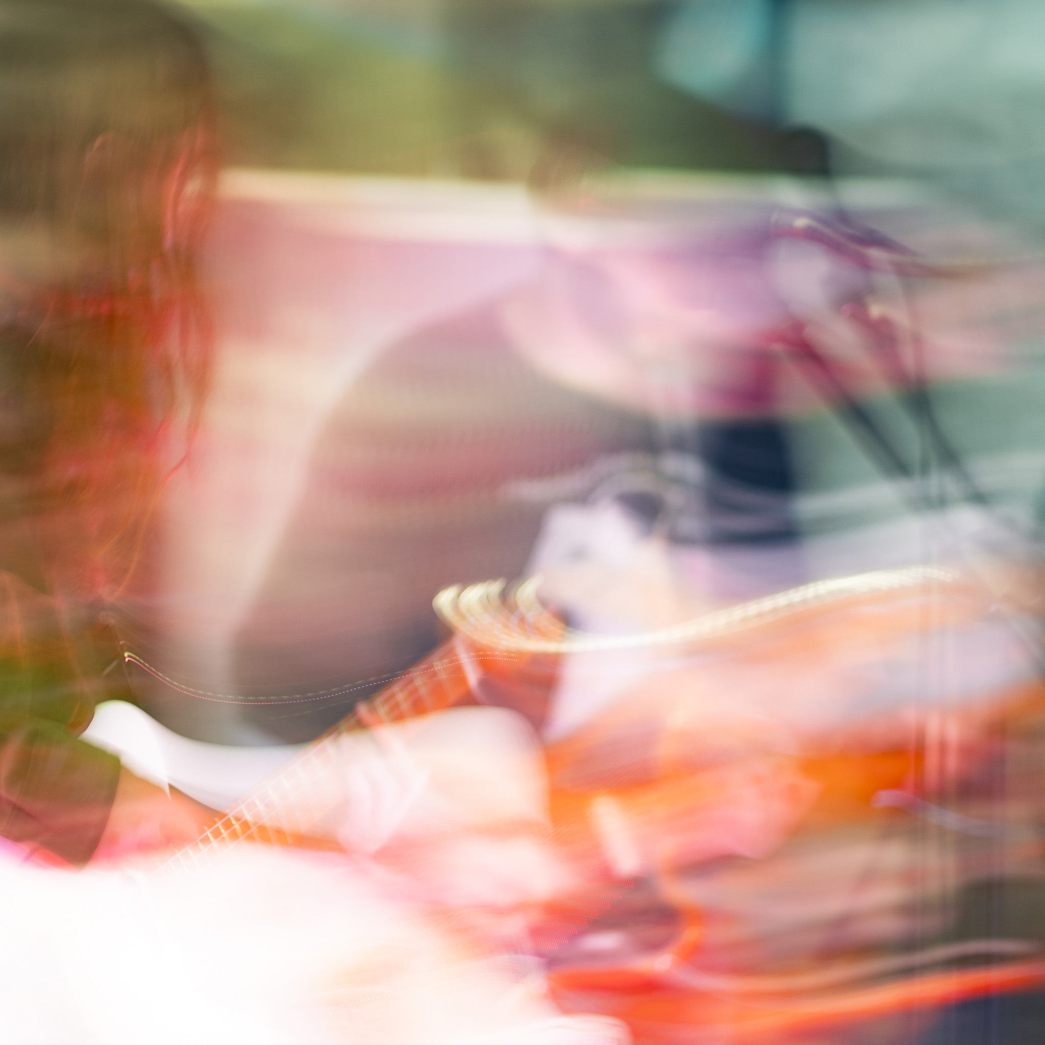 a blurry image of a person playing a guitar