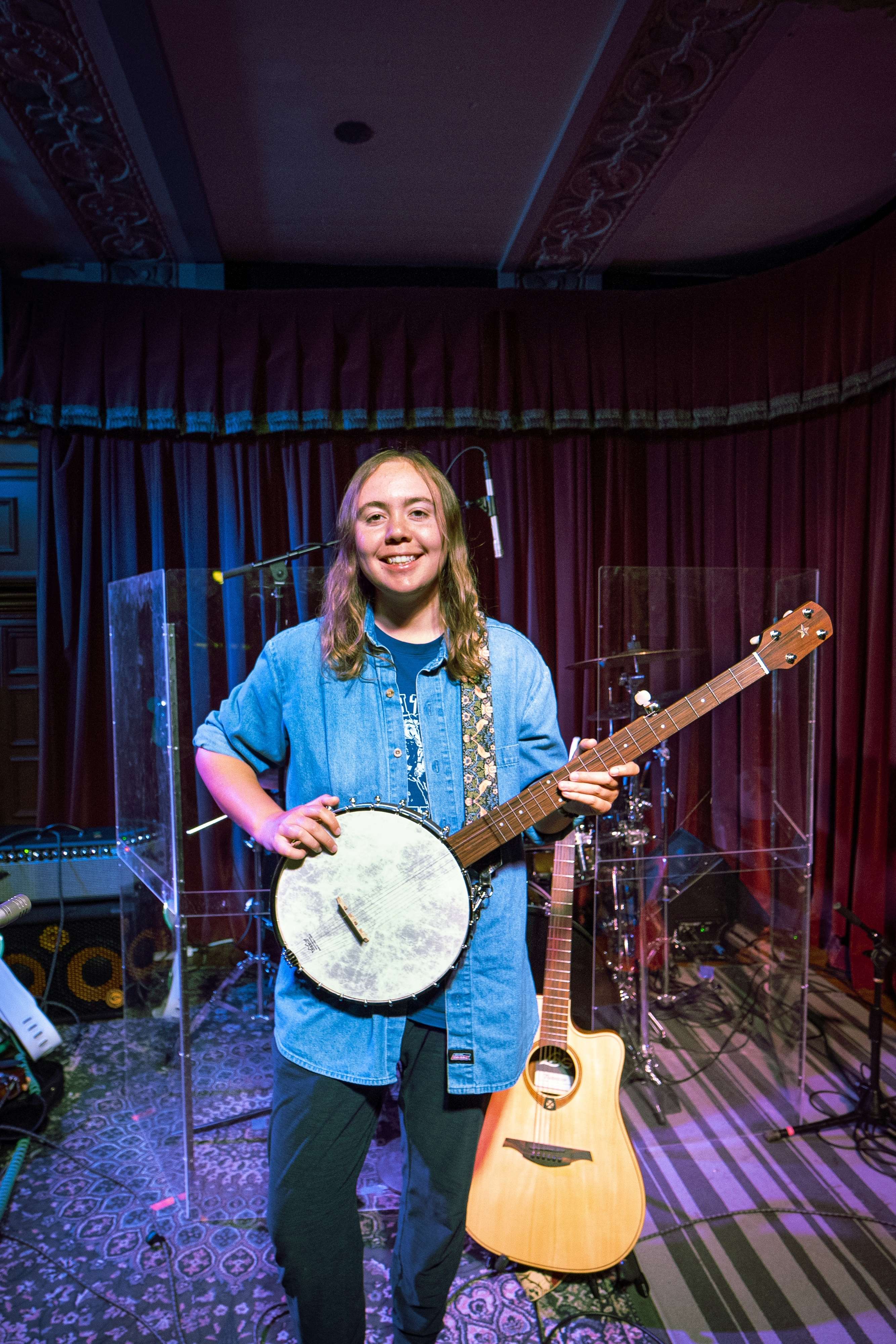 a young man holding a banjo