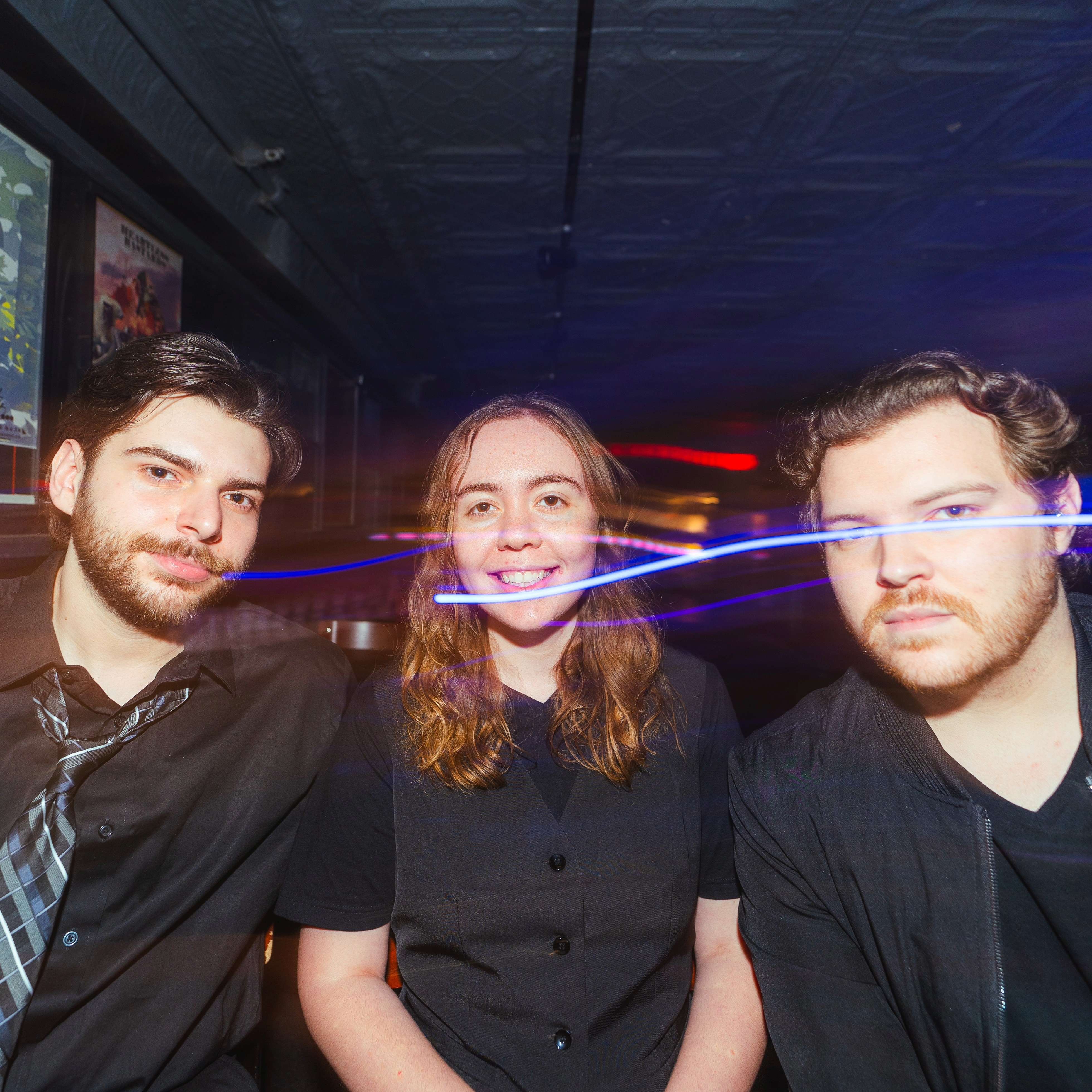 a group of people posing for a picture in a bar