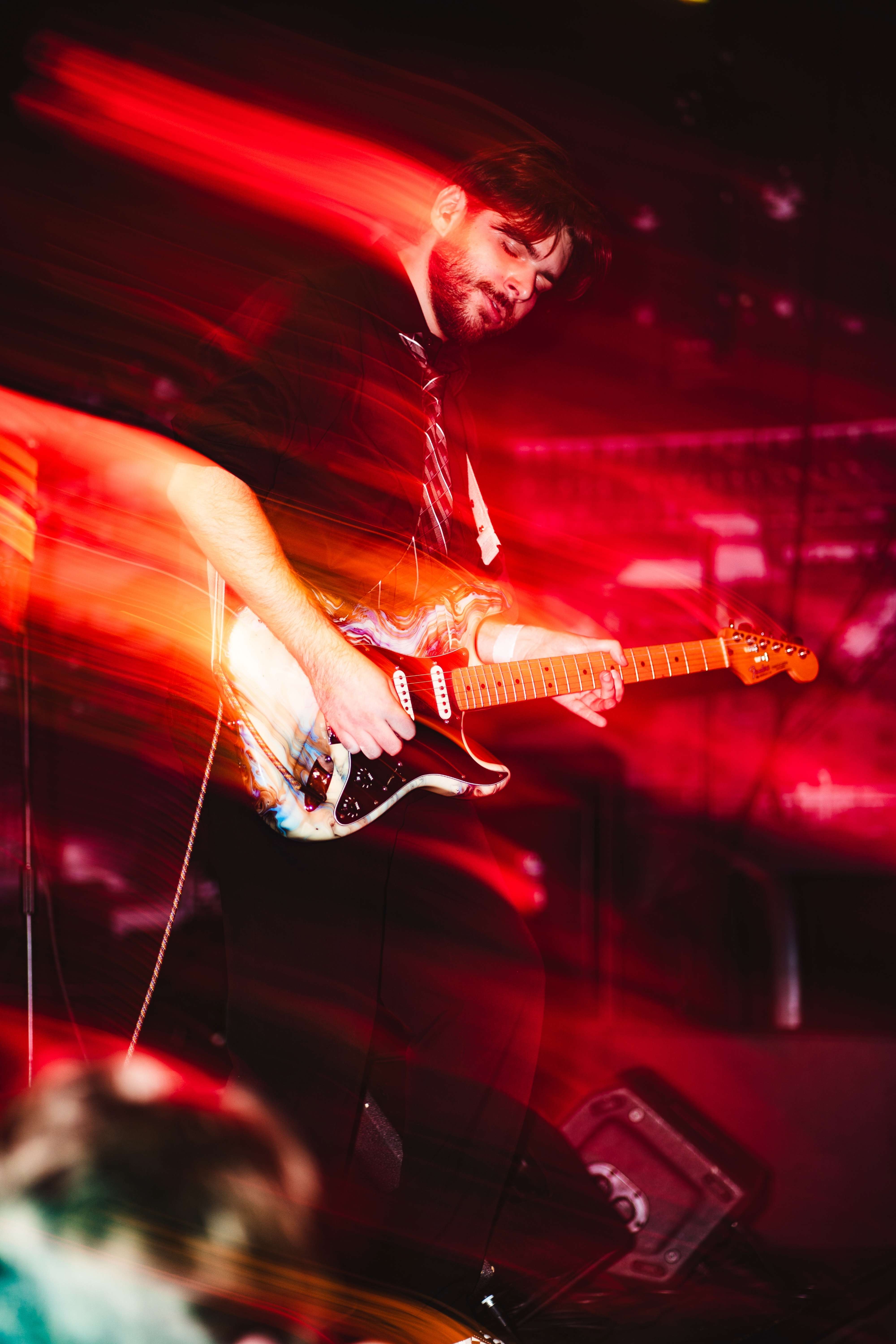 a man playing a guitar at a concert