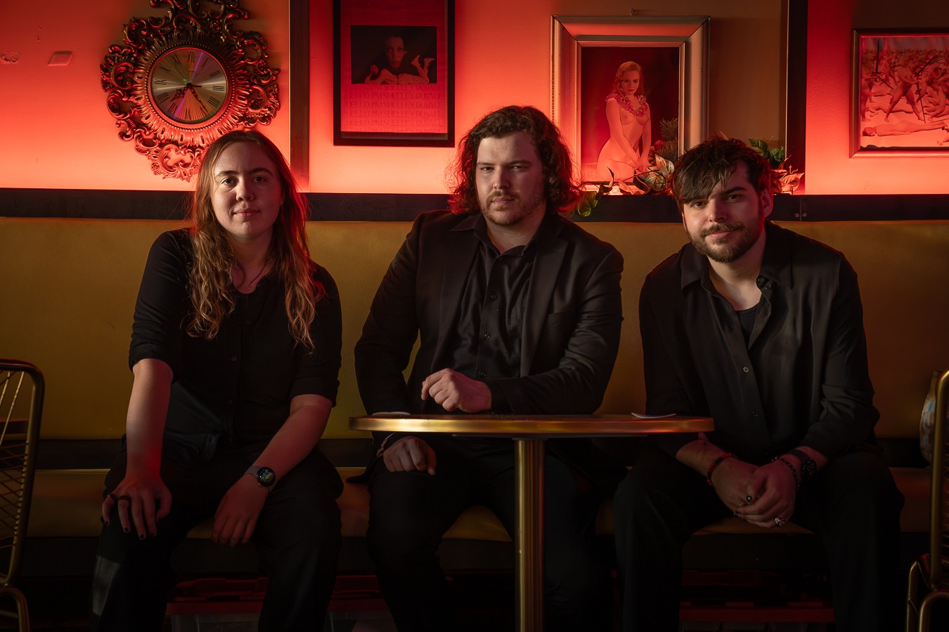 a group of people sitting at a table in a dark room