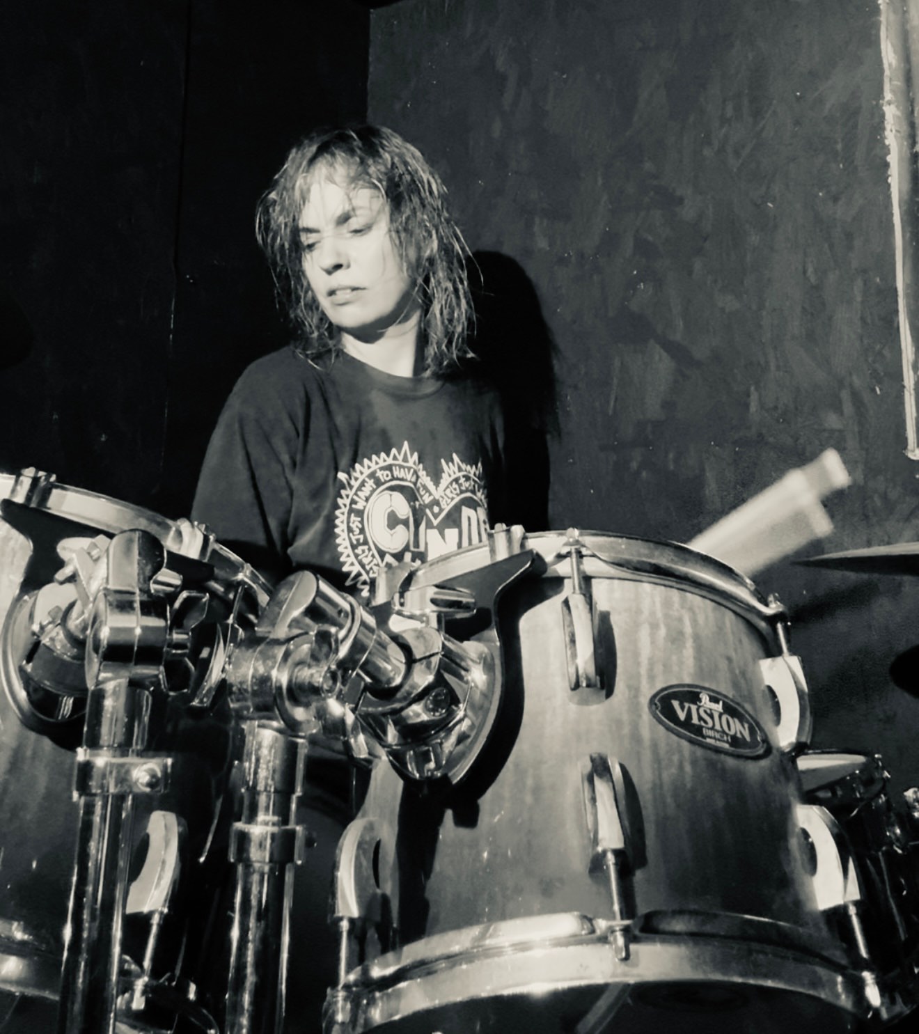 a black and white photo of a man playing drums
