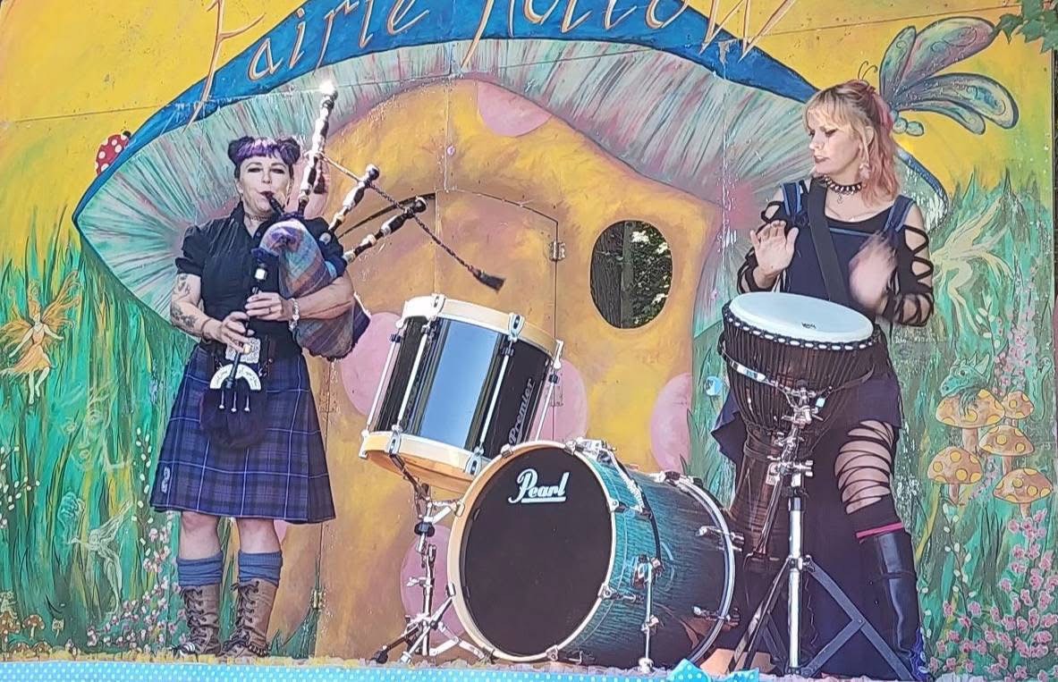 a mural of a woman playing a bagpipe and a man playing drums