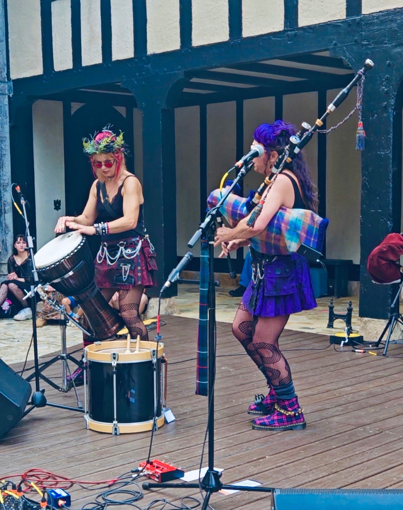 a group of women playing instruments on a wooden deck
