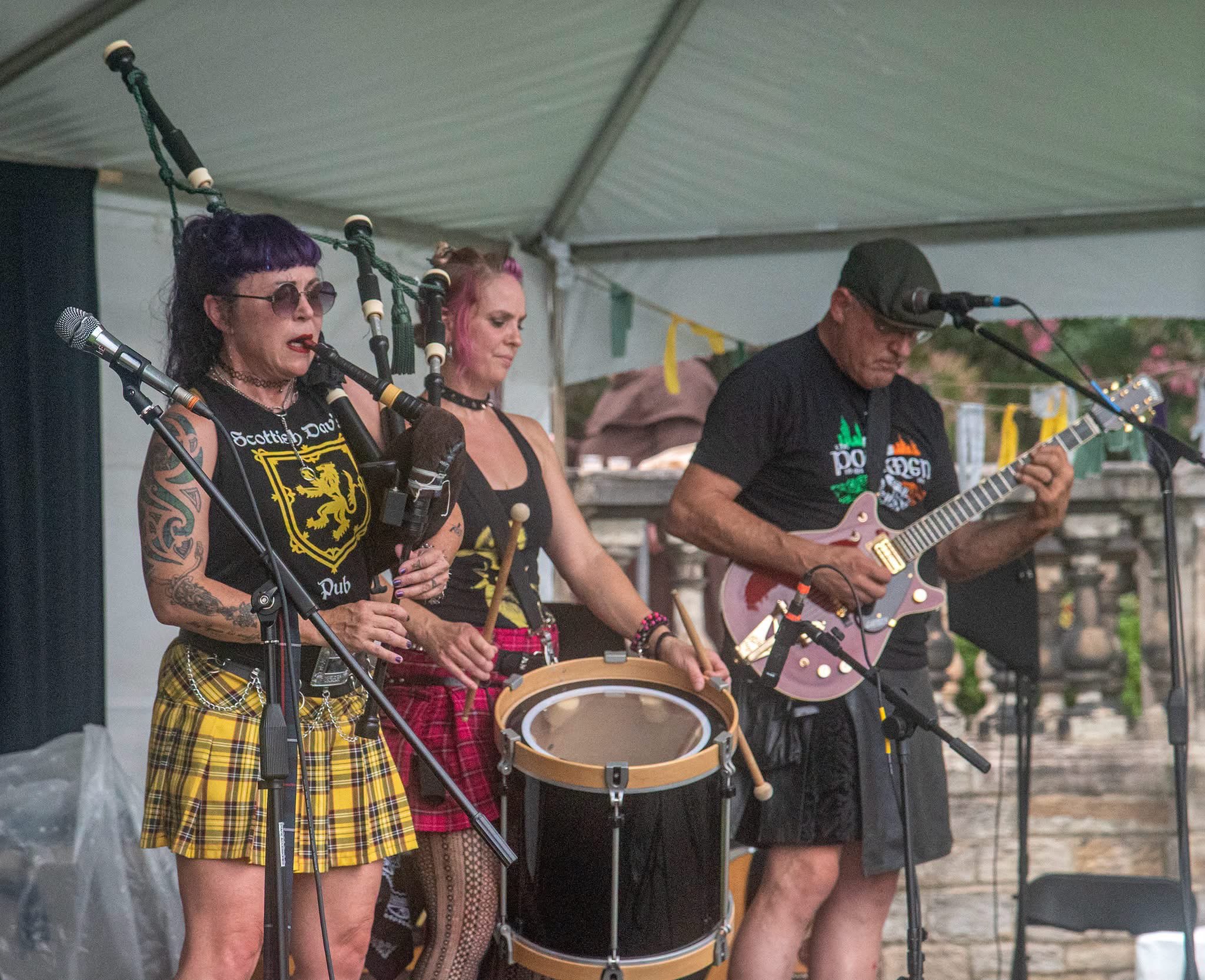 a group of people in kilts playing music