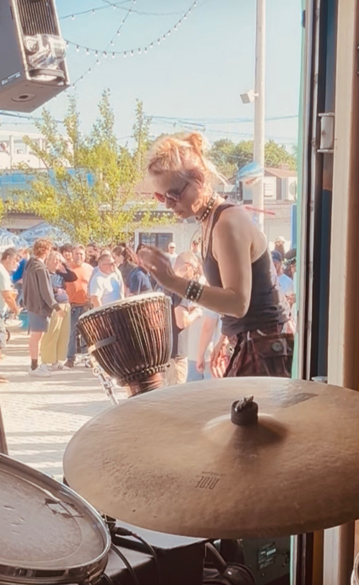 a woman playing drums in front of a crowd