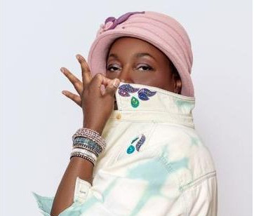 a woman wearing a pink hat and denim jacket