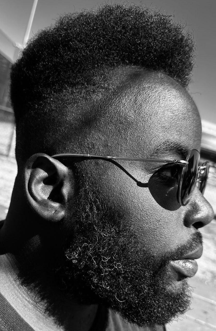 a black man with a beard and sunglasses