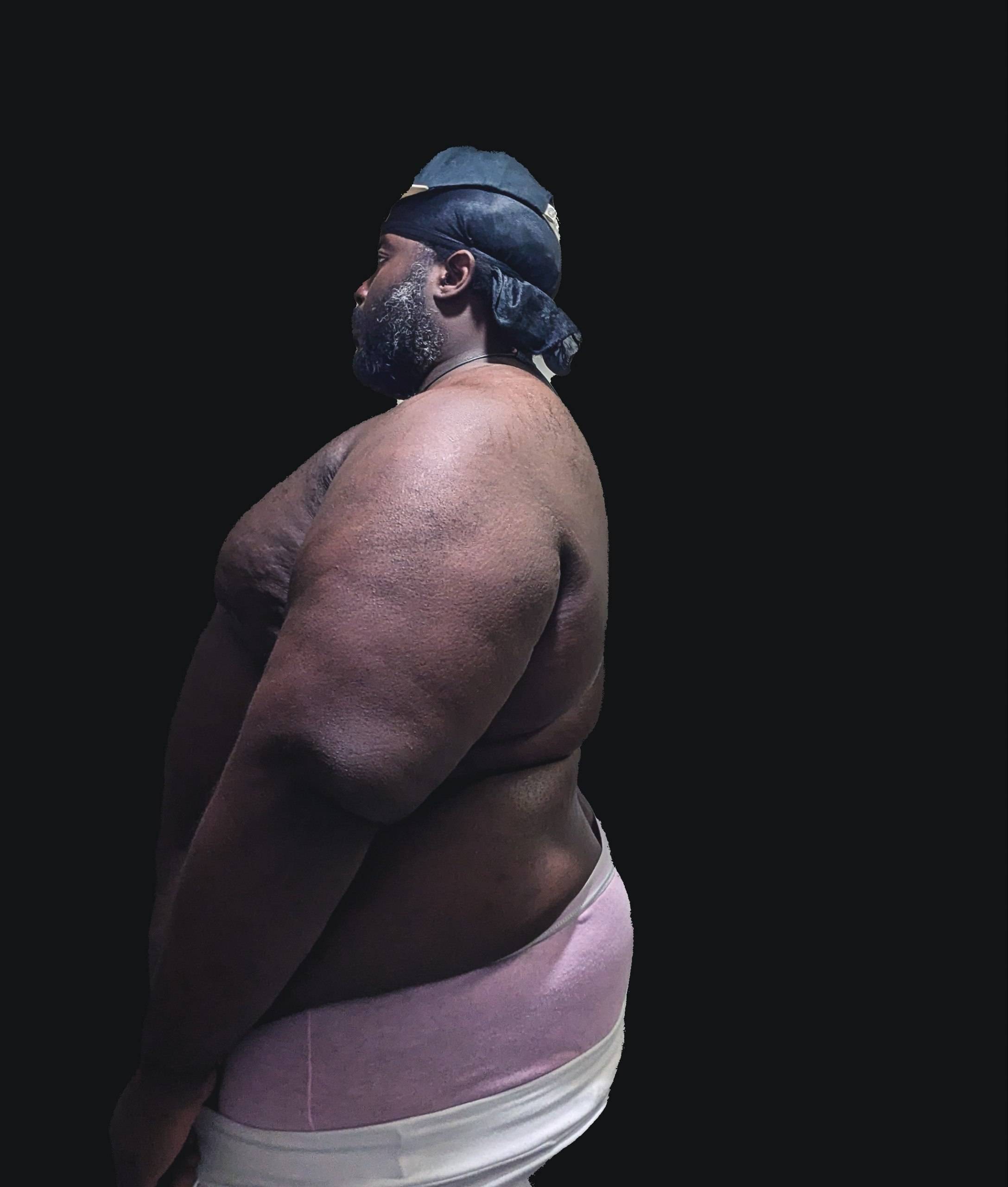 a black man with a hat and pants