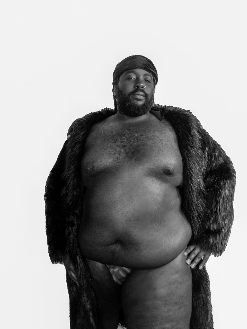 a black man in a fur coat posing for a photo
