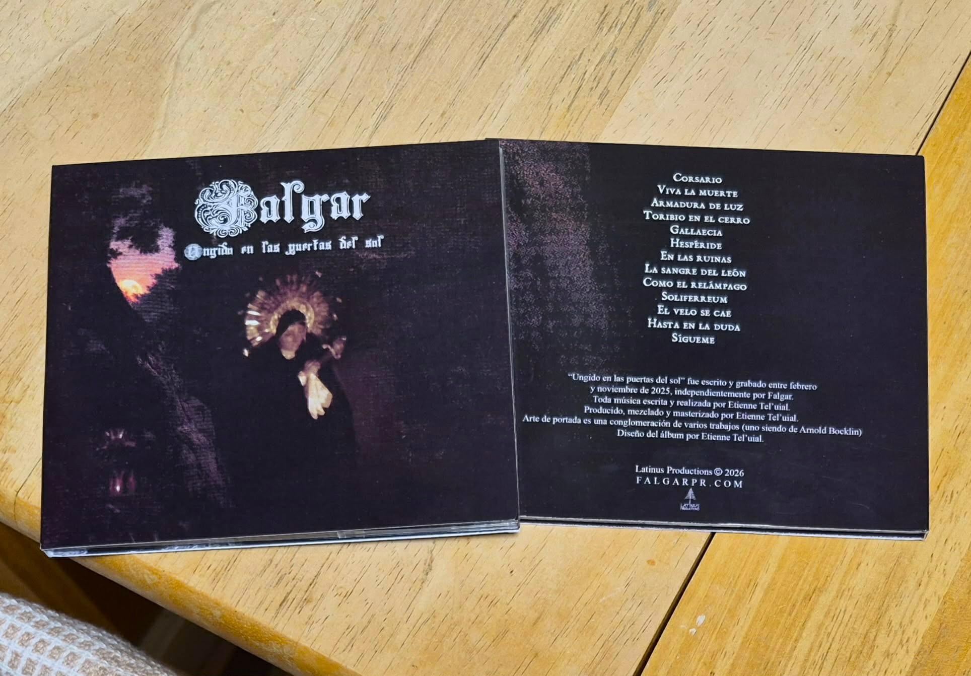 a cd with a black cover on a wooden table