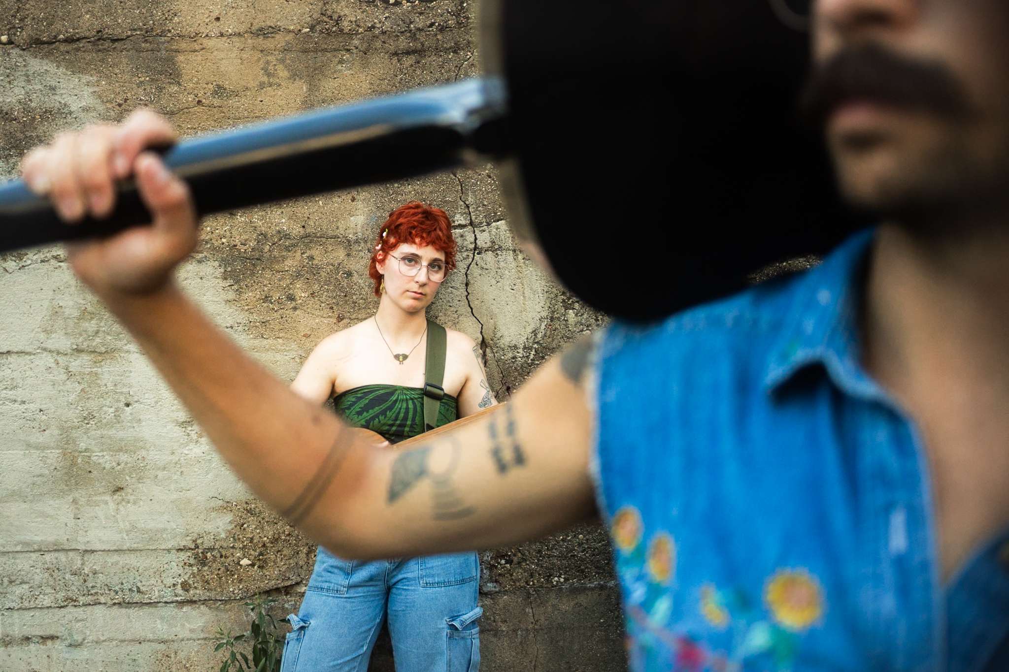 a man holding a guitar and a woman with red hair