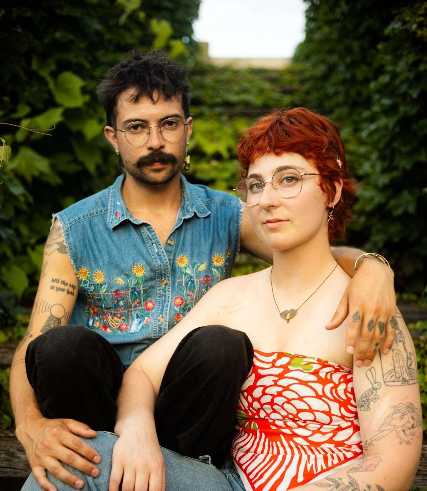 a man and woman with tattoos posing for a photo