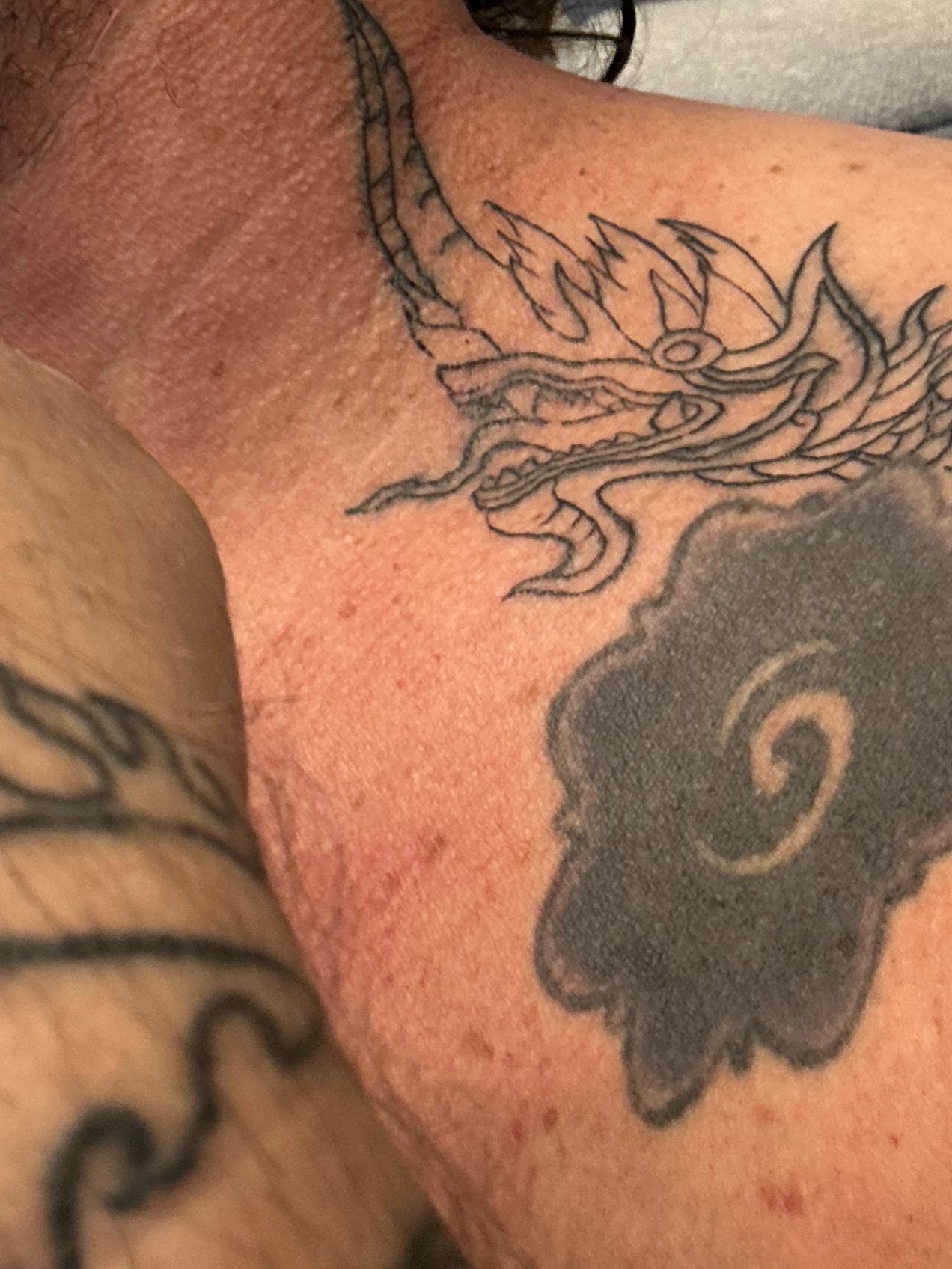 a man with a tattoo on his chest