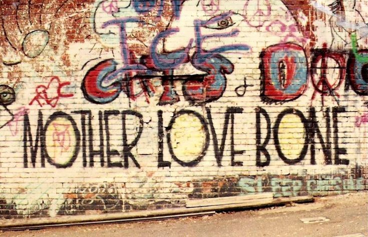 a graffiti covered wall with the words mother love bone