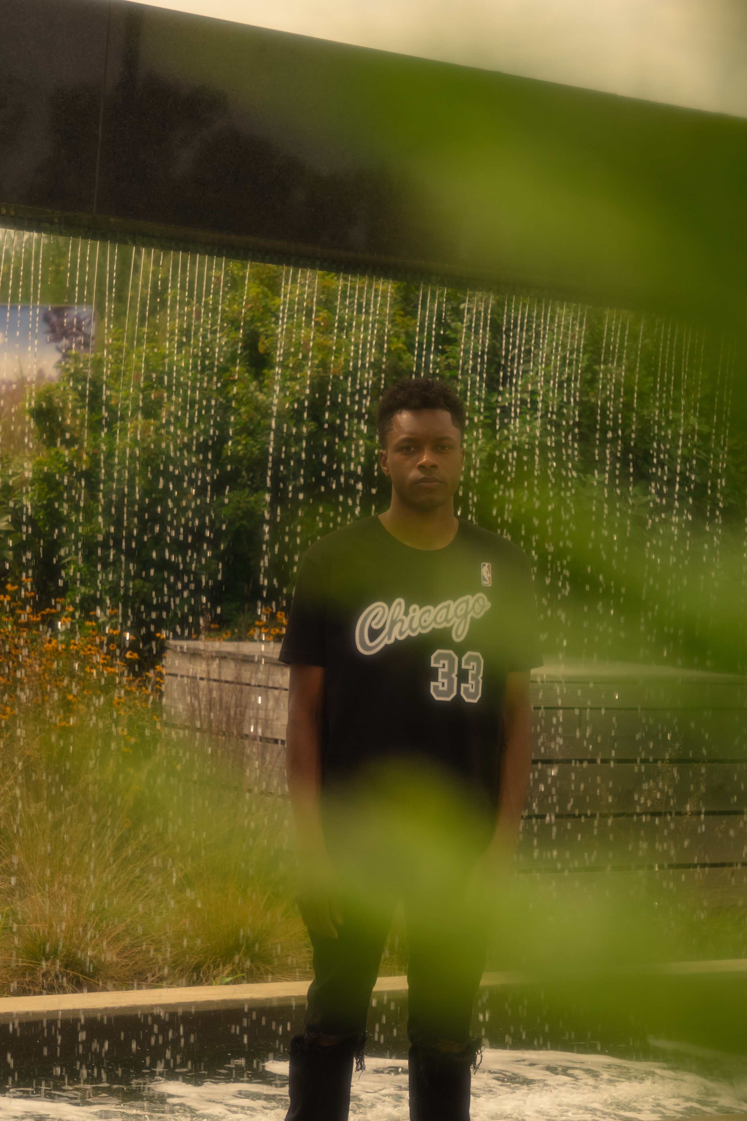 a man standing in front of a water fountain