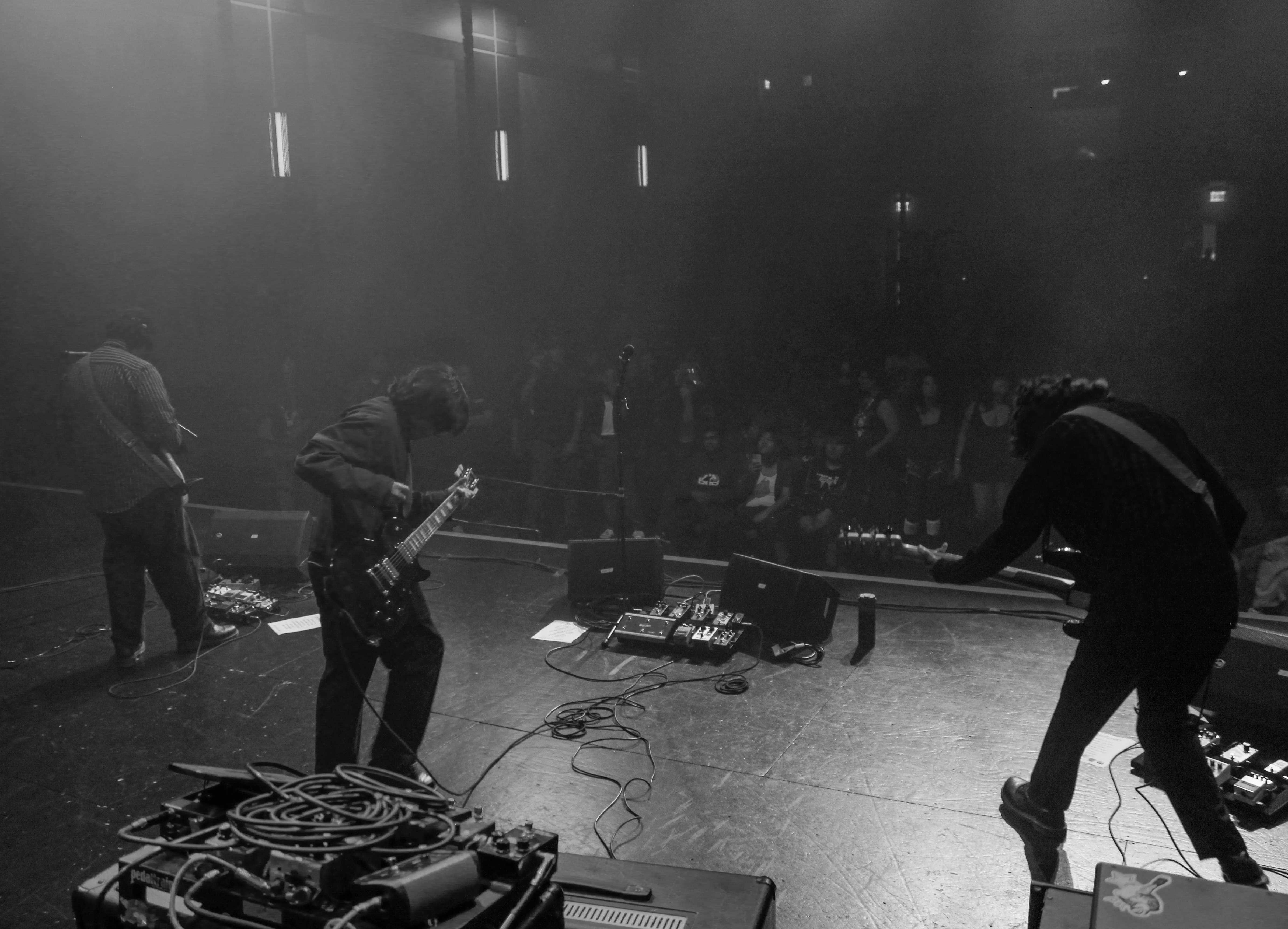 a black and white photo of a group of people on stage
