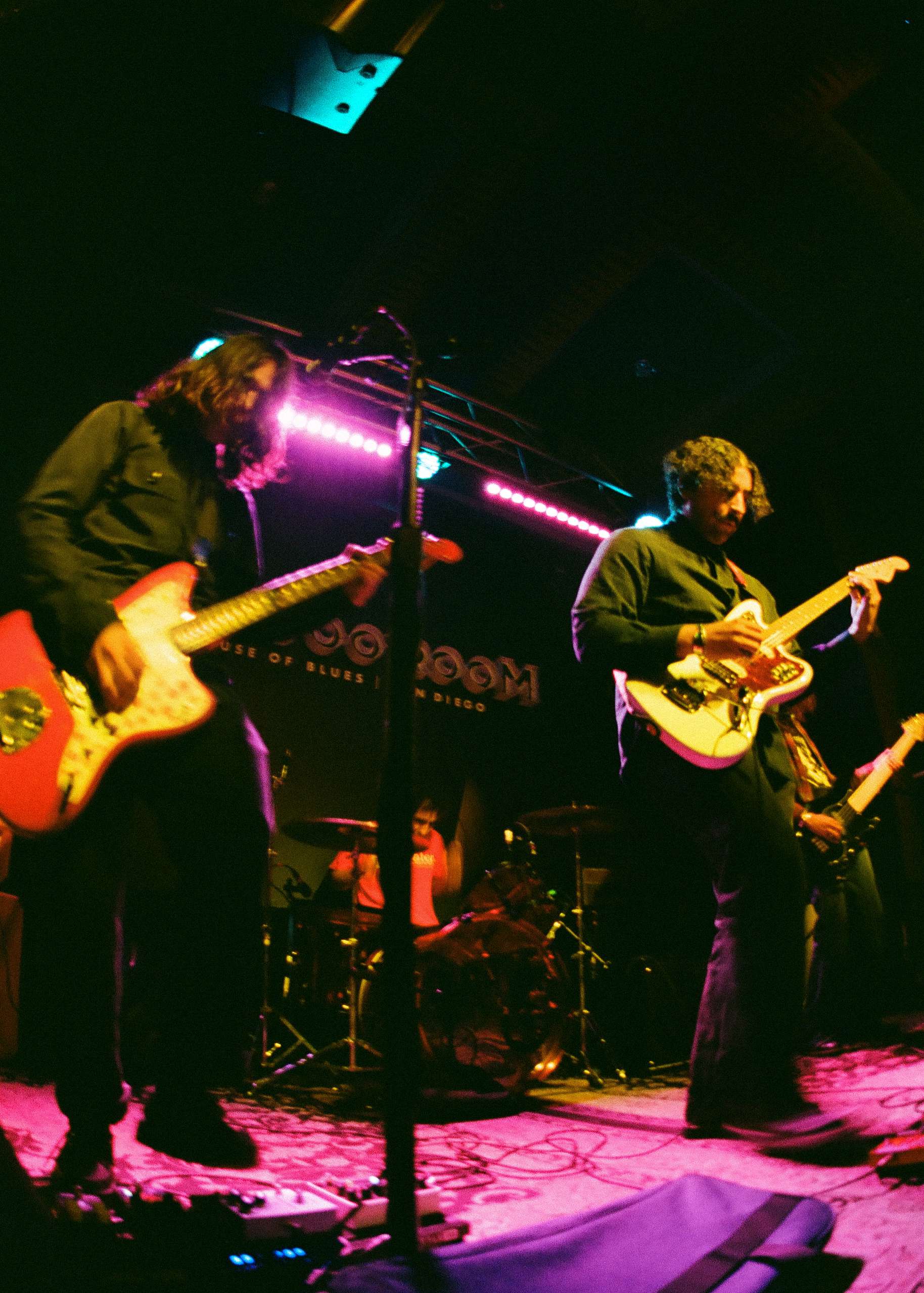 a group of people playing guitars on stage