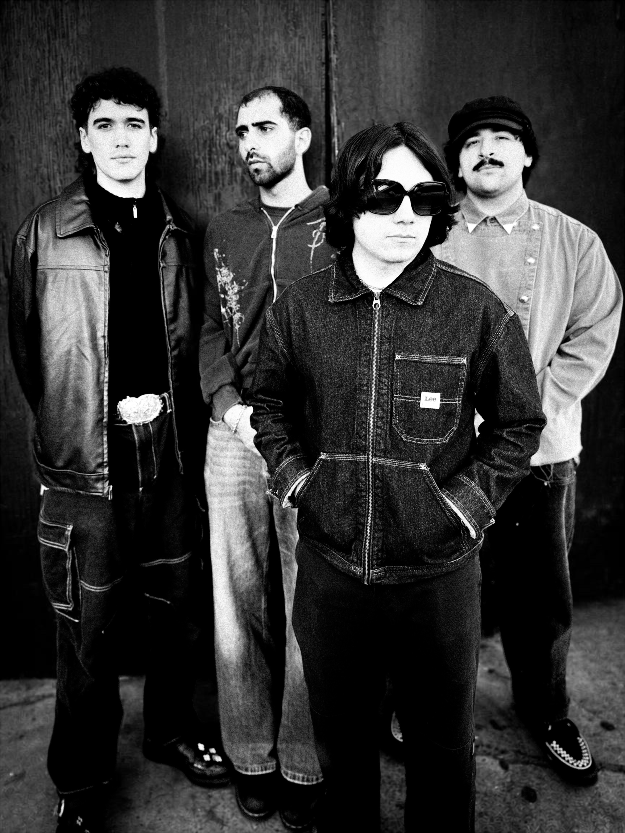a black and white photo of a group of men standing next to each other