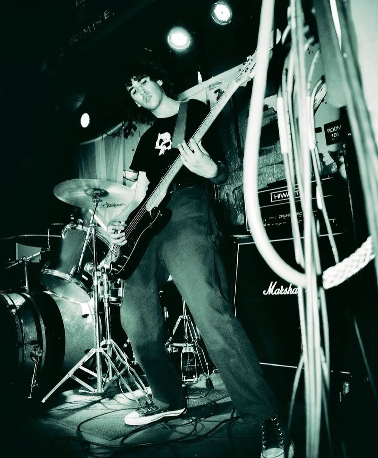 a man playing a guitar in a dark room
