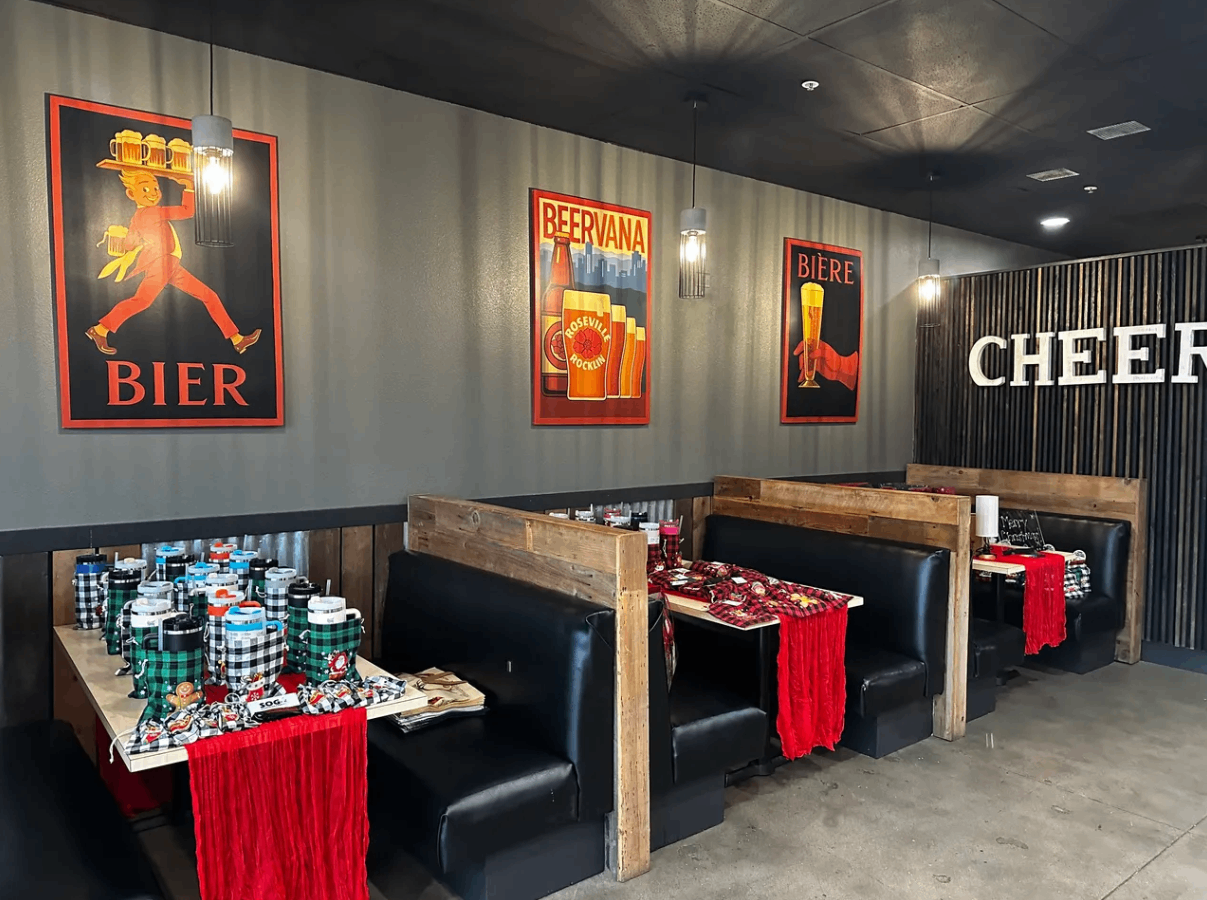 a restaurant with tables and chairs and a sign that says cheers