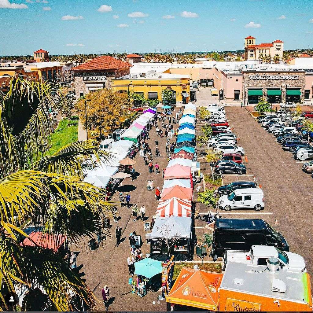 an aerial view of a market in a parking lot