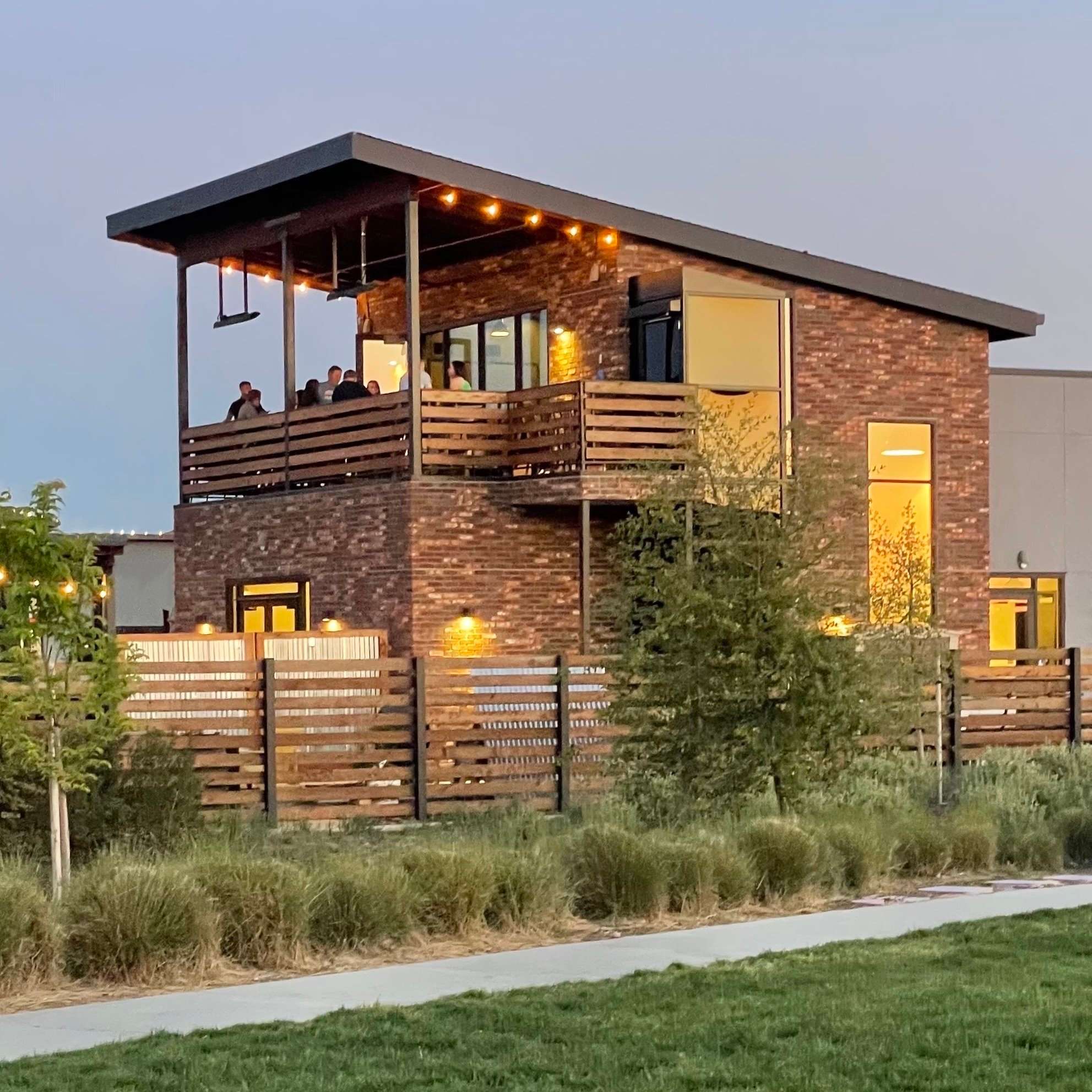 a modern home with a wooden deck and fence