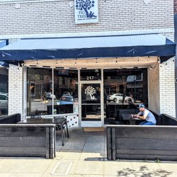 the outside of a restaurant with a blue awning