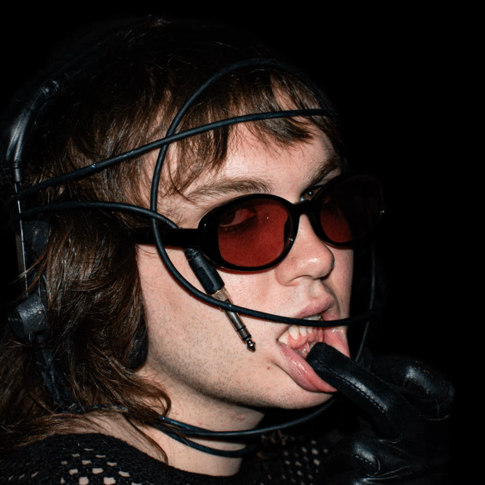 a man wearing a black mask and black gloves