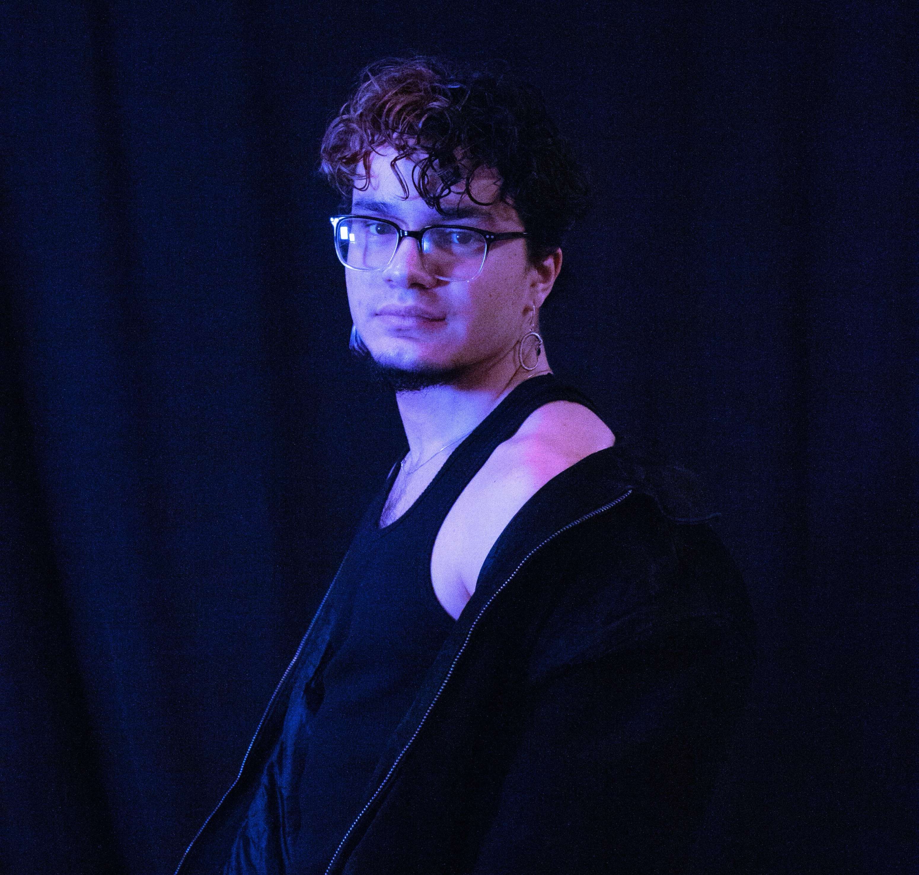 a man wearing glasses and a black jacket