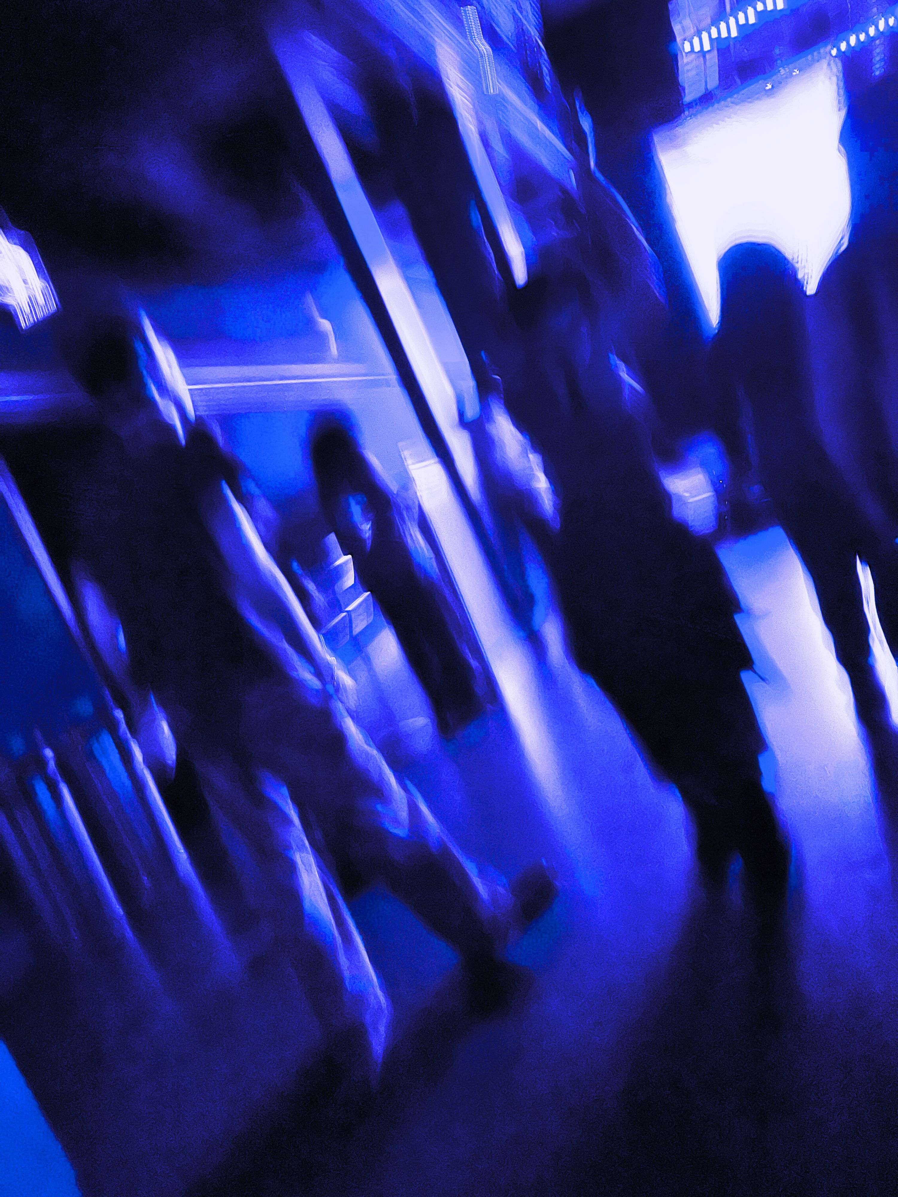 a group of people walking in a dark room