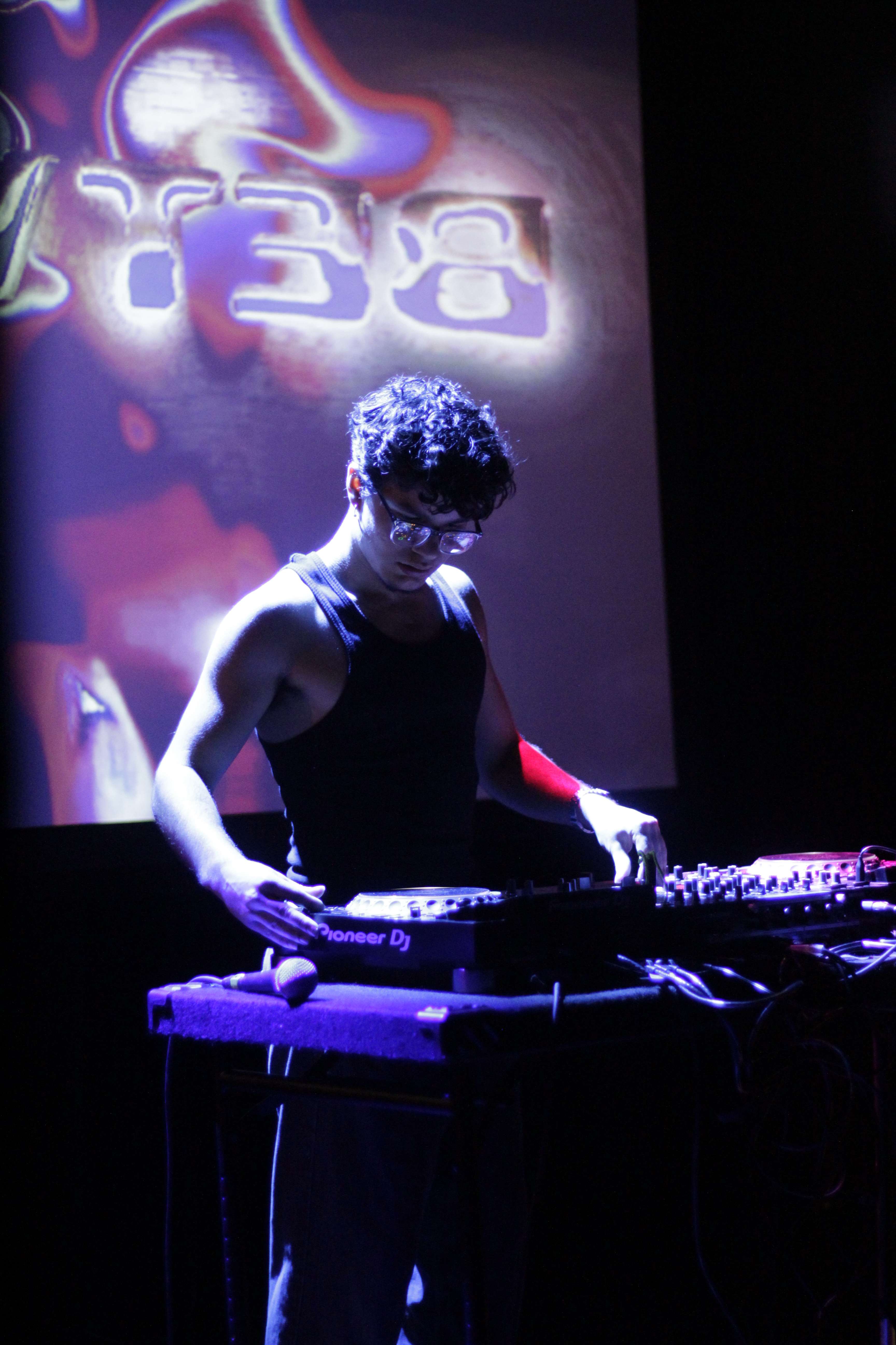a man is playing a dj set on a stage