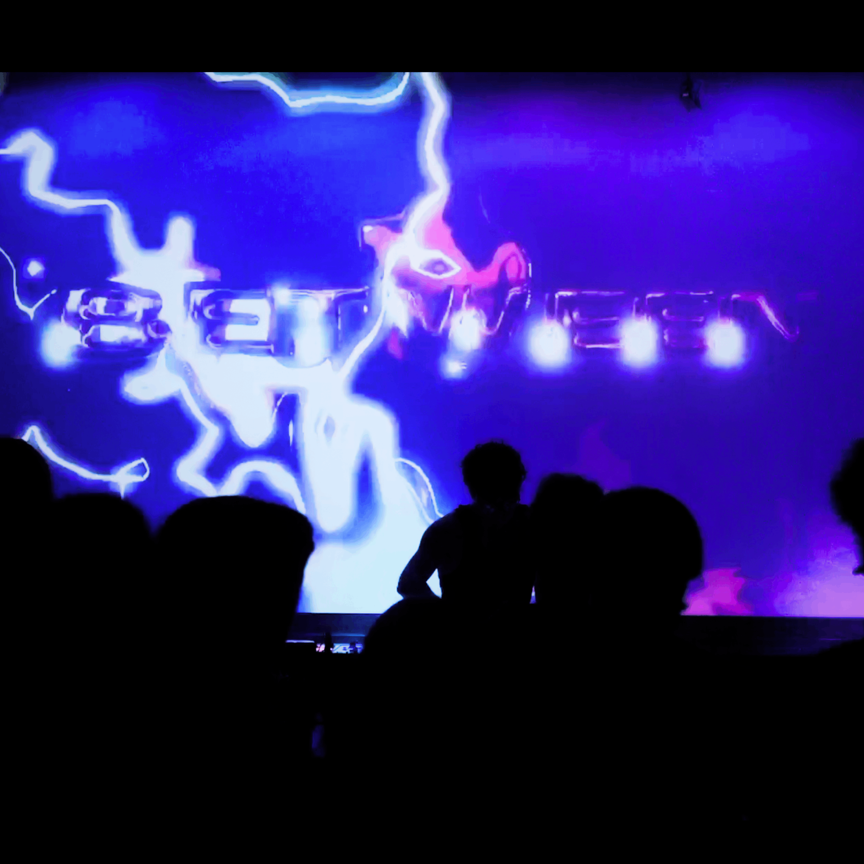 a group of people standing in front of a purple screen