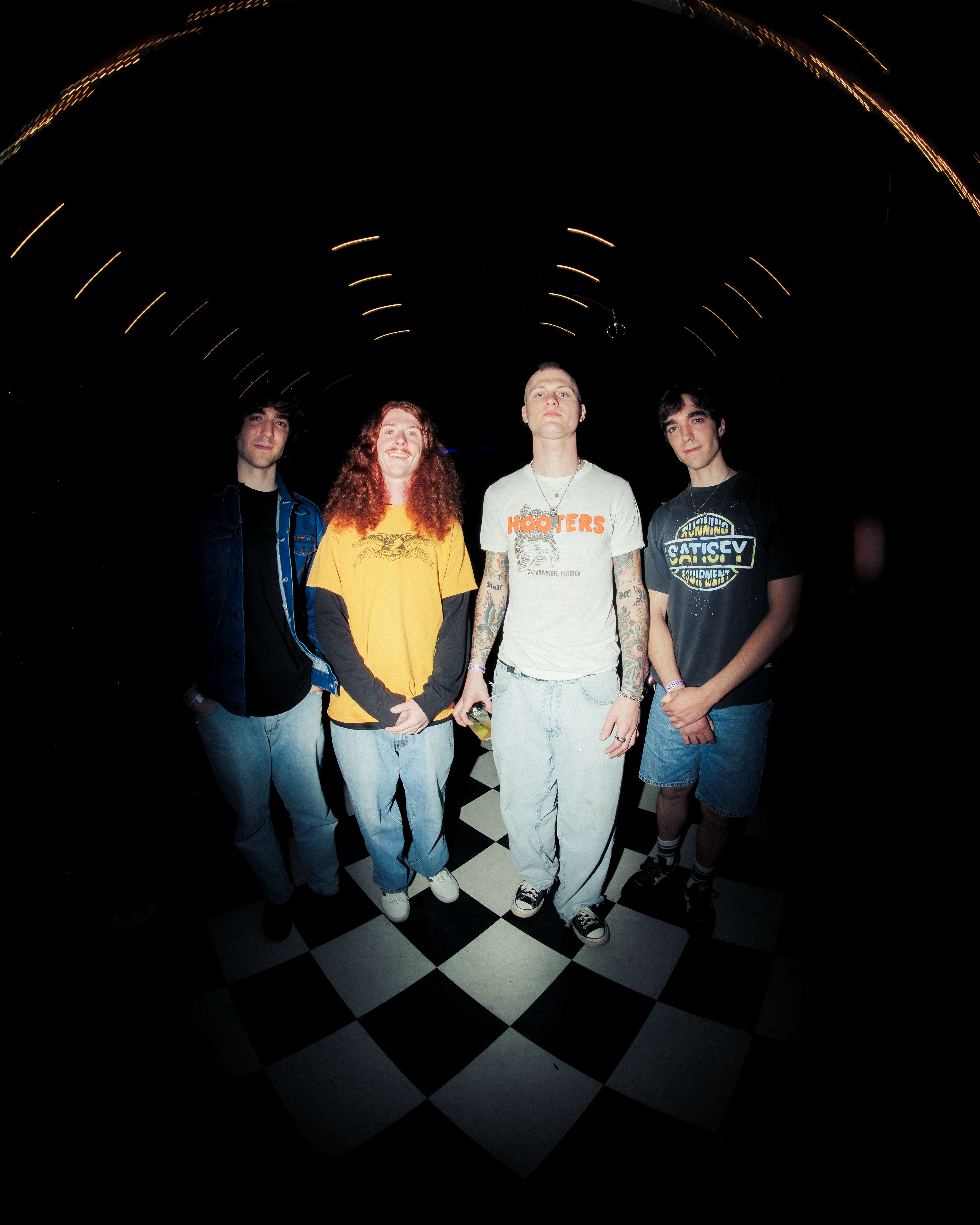 a group of people standing in a checkered room