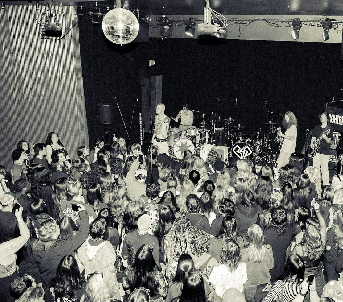 a black and white photo of a crowd at a concert