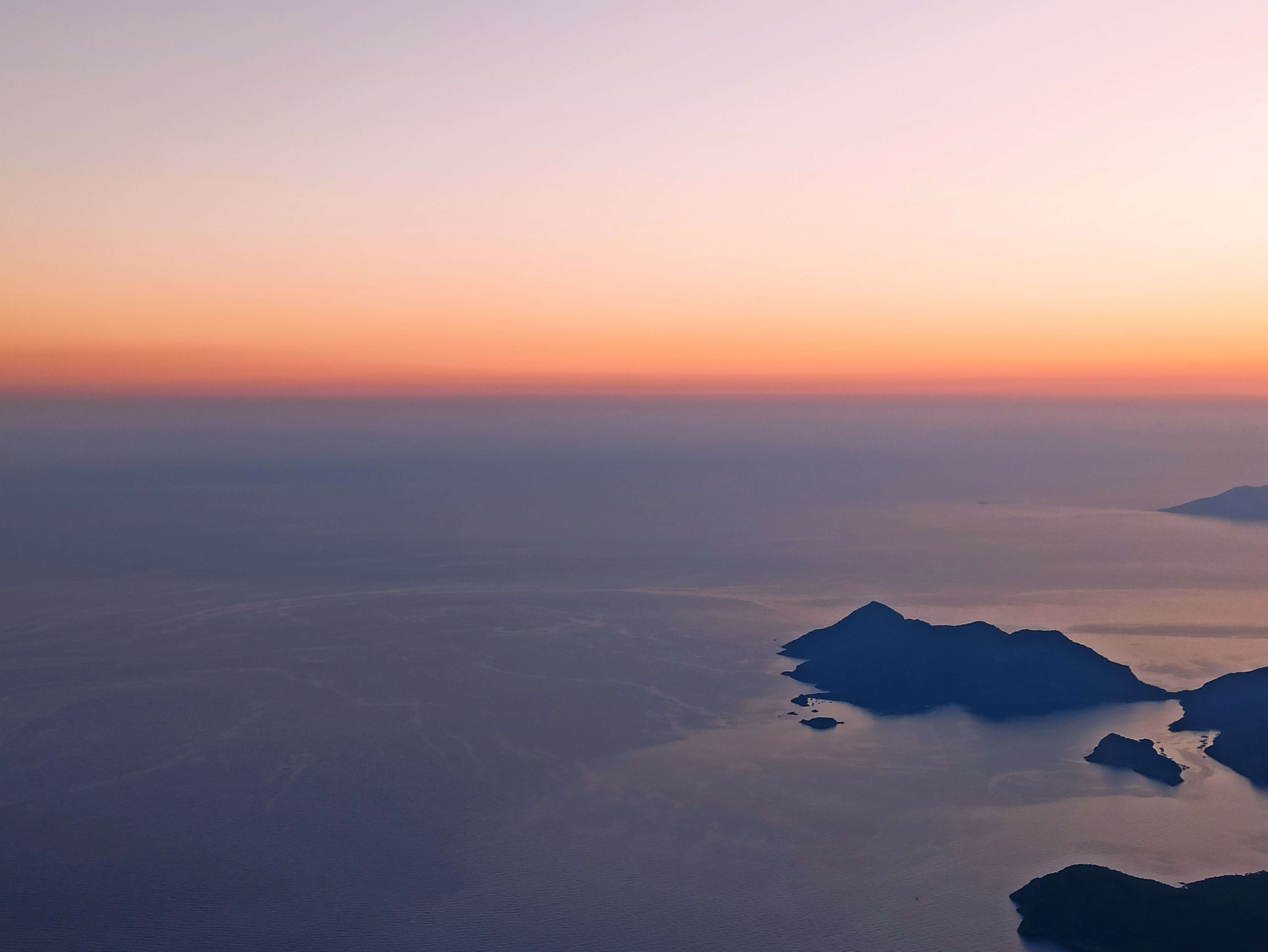 an aerial view of an island at sunset