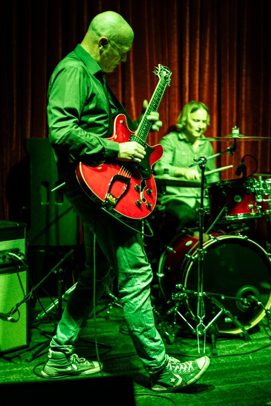 image may contain person, on stage and playing a musical instrument