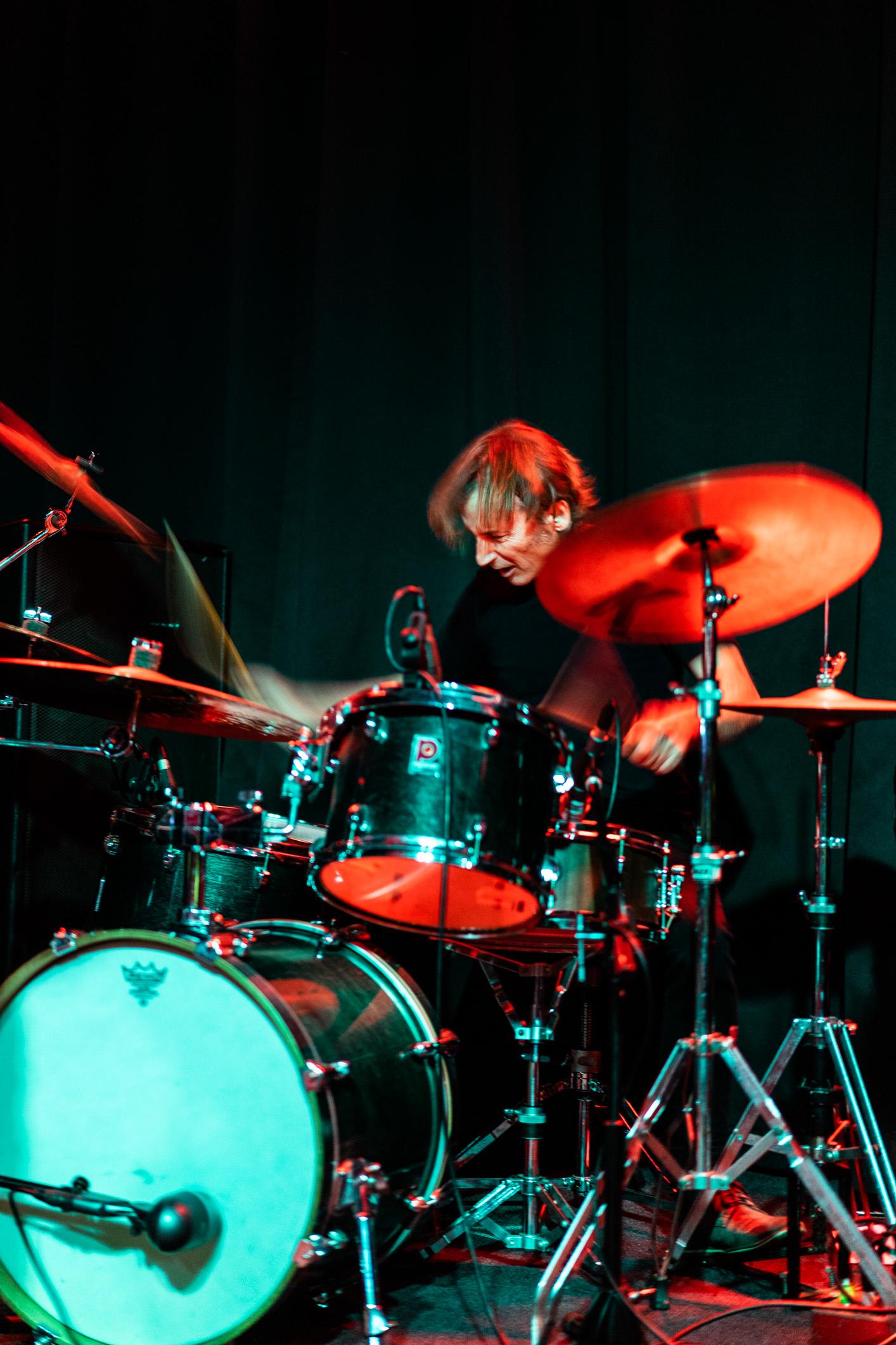 a man playing drums on a stage