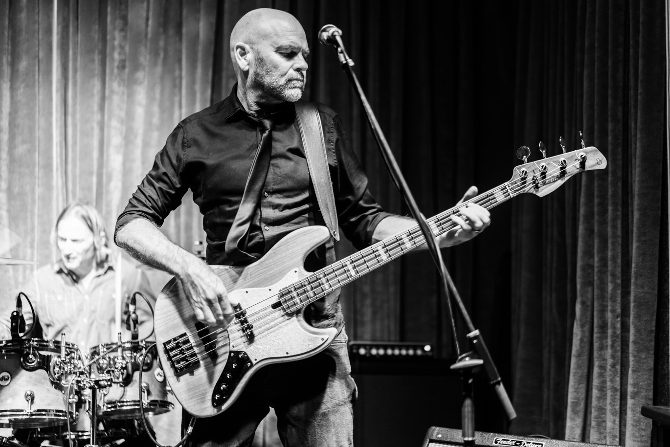 image may contain person, playing a musical instrument, on stage and guitar