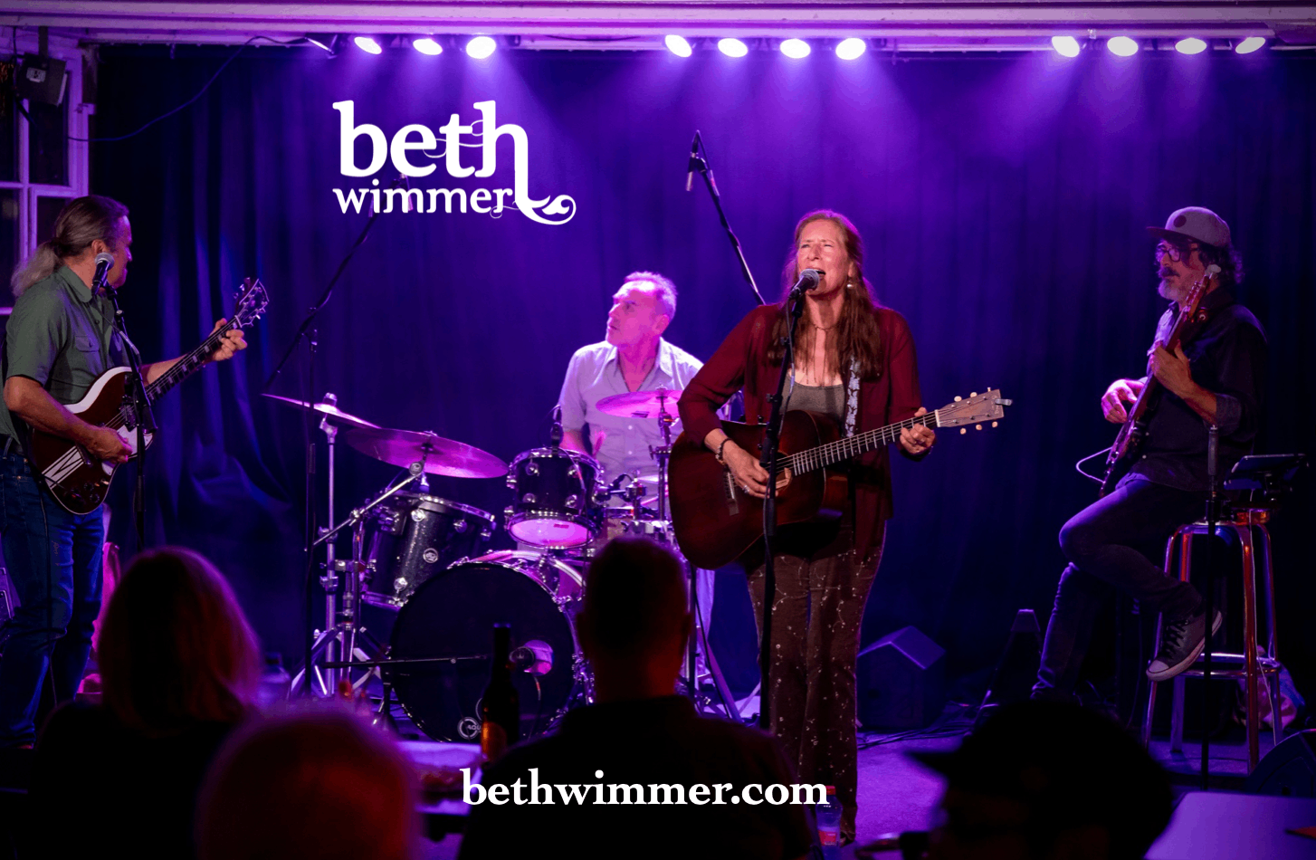 a group of people playing music on stage