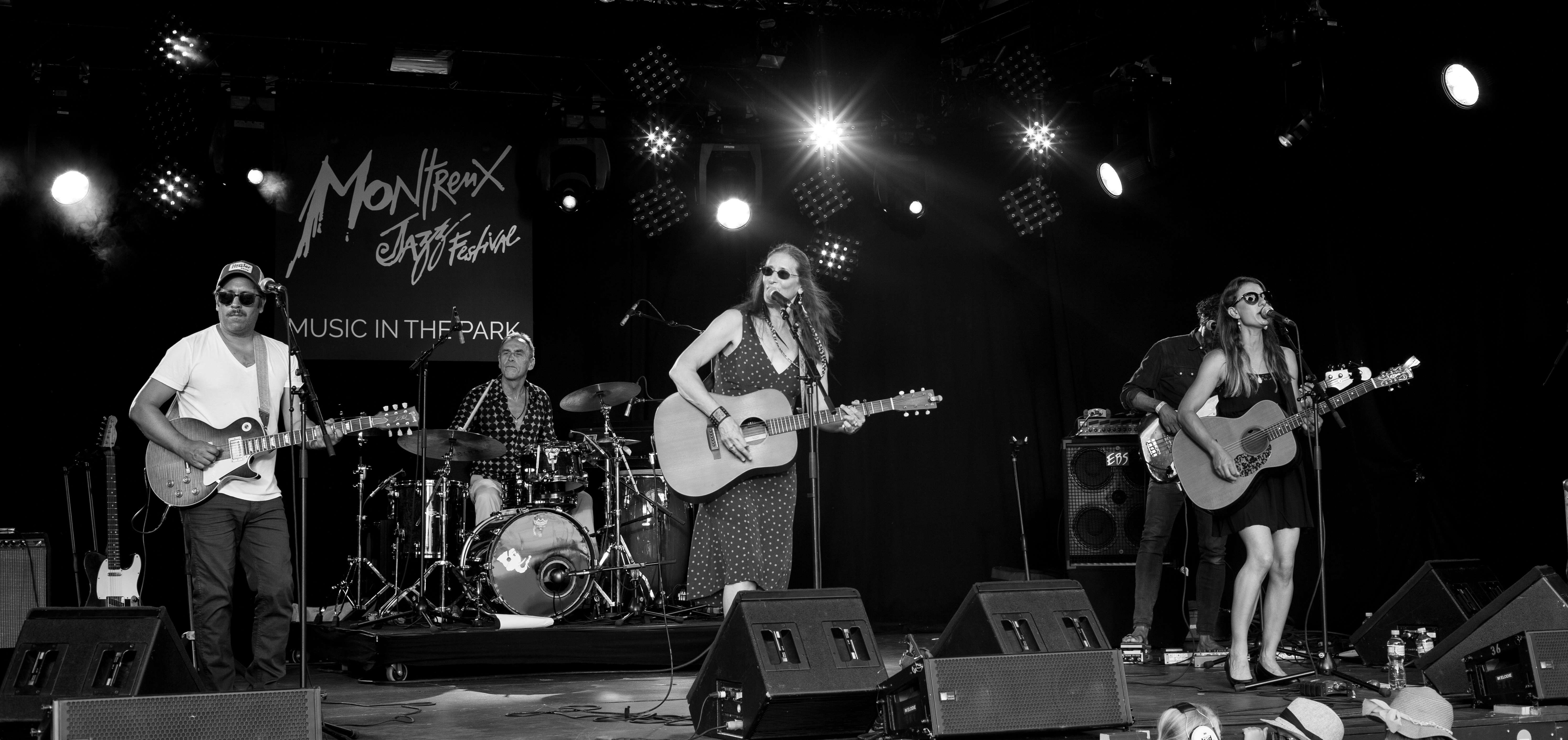 a black and white photo of a group of people on stage