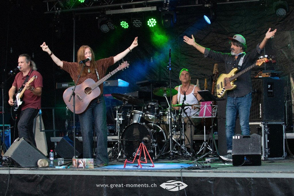 a group of people on stage with guitars and drums