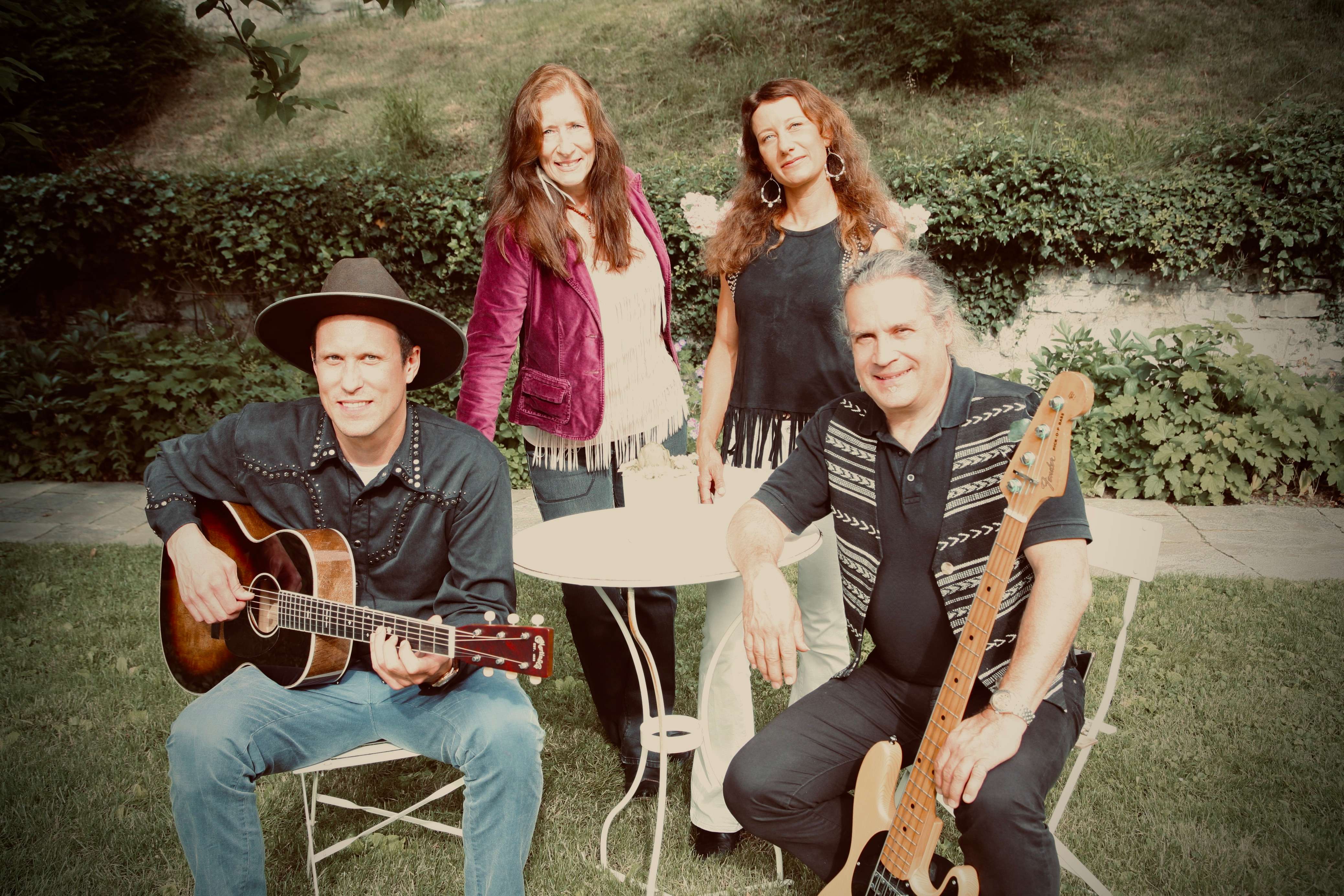 a group of people posing for a picture with guitars