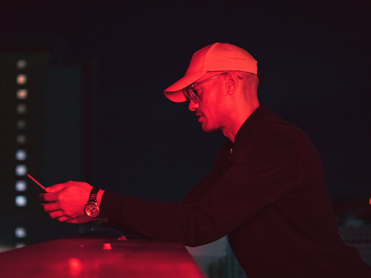 Strategy - TELL DEM (Johnny Mahon Edits): a man using a cell phone at night