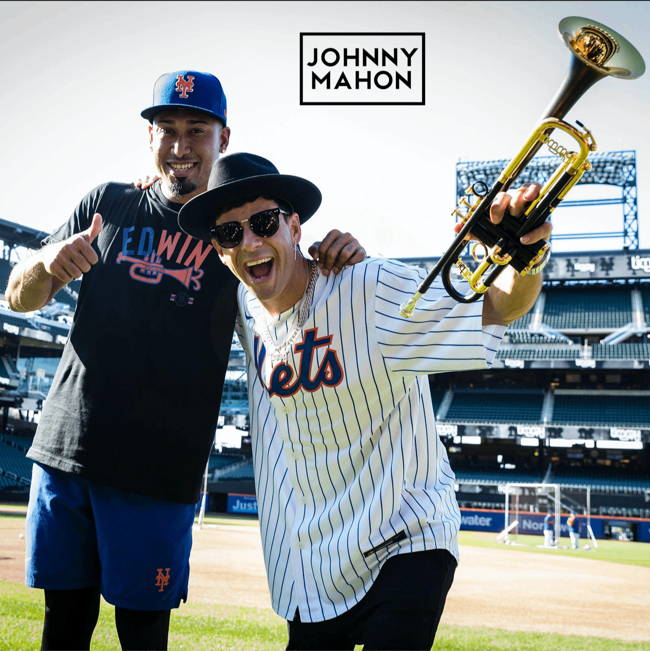 johnny mahon and johnny martin pose for a photo in a baseball field
