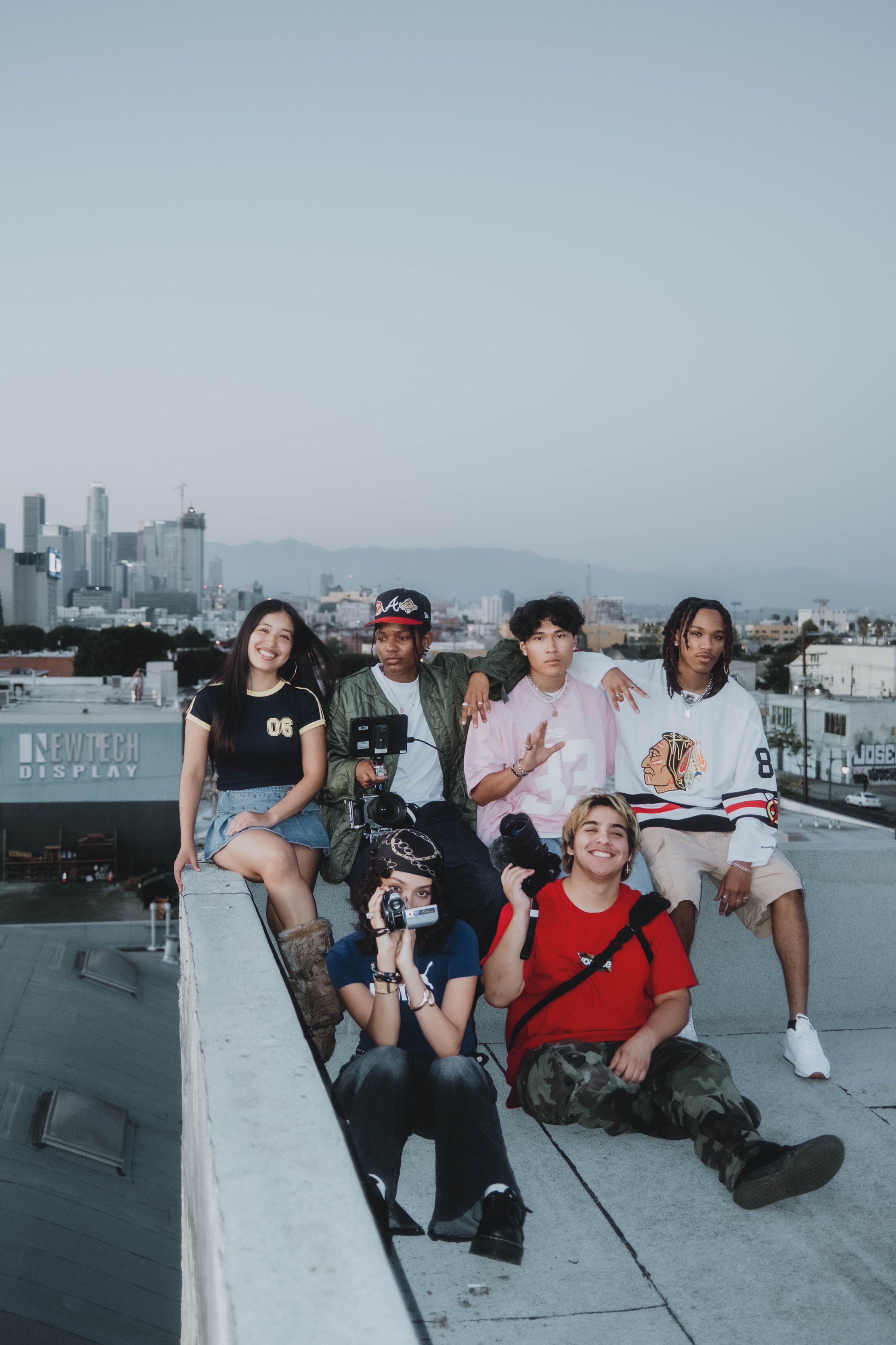 a group of people posing on a rooftop