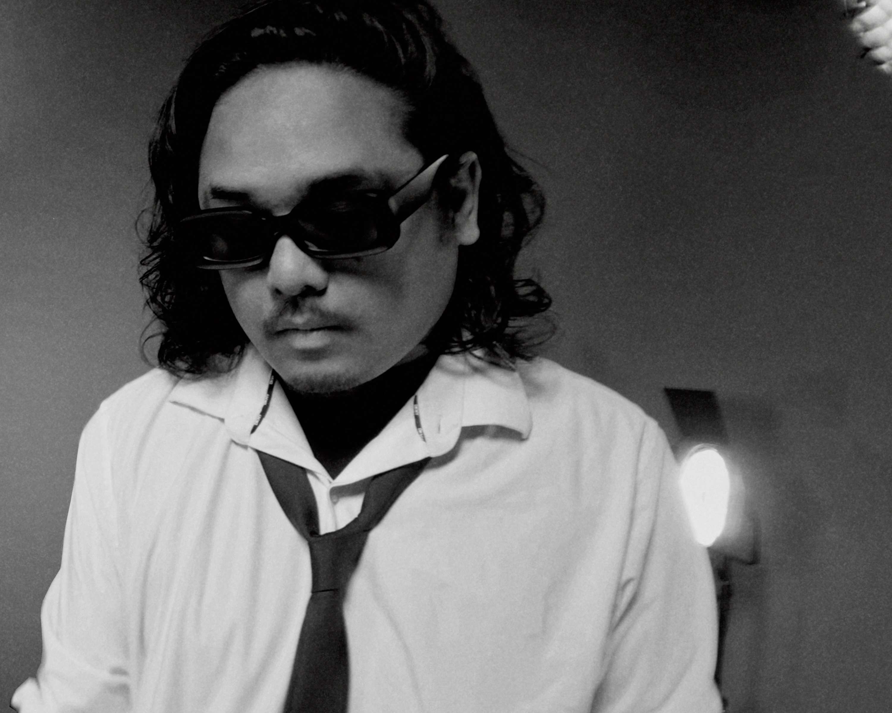 a man wearing sunglasses and a tie